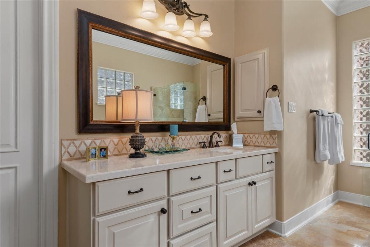 5530 Regal Landing Drive, Kingwood, TX 77345 Light marble counter tops and back splash compliment the honed travertine tile floor.