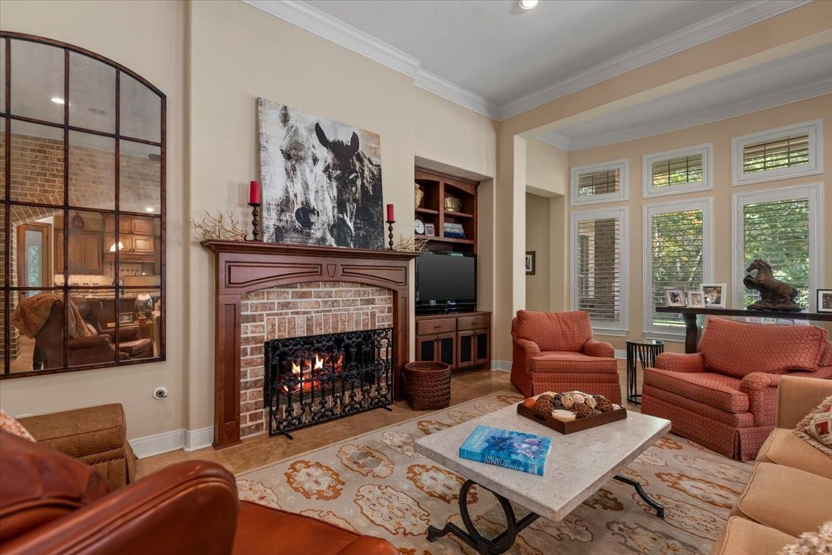 5530 Regal Landing Drive, Kingwood, TX 77345 The brick gas log fireplace compliments the brick archway.