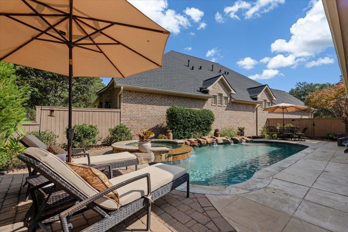 5530 Regal Landing Drive, Kingwood, TX 77345 Gorgeous! The pool equipment and AC are located behind the wood fence at the far end of this photo.