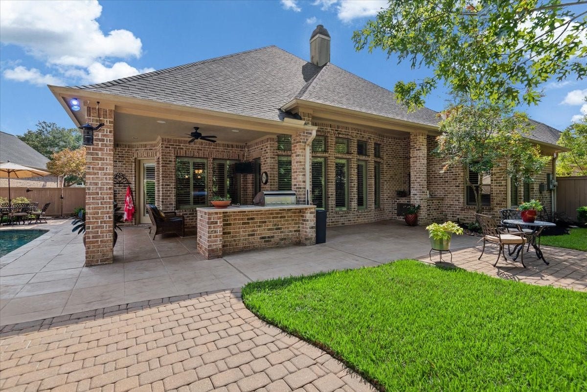 5530 Regal Landing Drive, Kingwood, TX 77345 Oh YES....we have a covered patio with decking that is beautifully tied into the pool area.