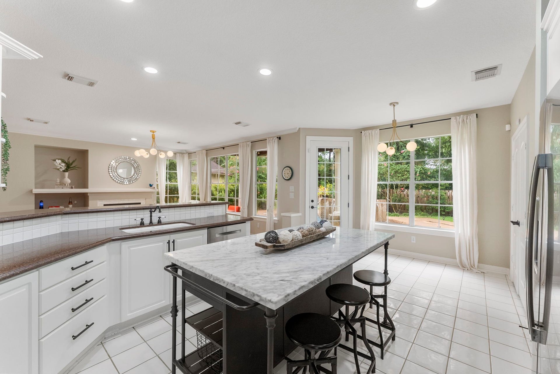 The island is movable, but it does offer a lot of counter space, even additional seating.  It conveys with the property.