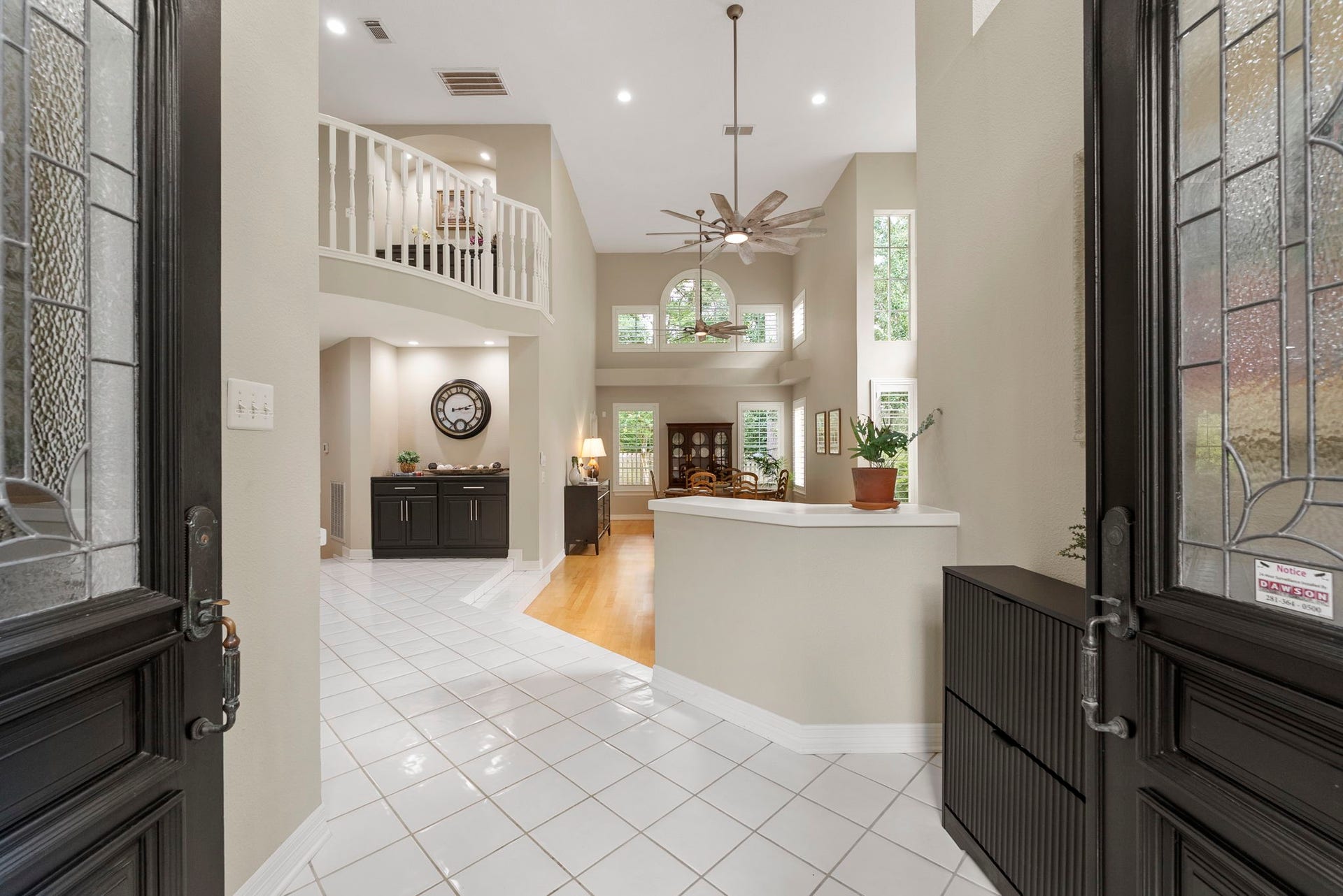 The double entry doors open into a grand entrance leading you into the Formal Living and Dining Room and a spiral staircase opens to the second floor.