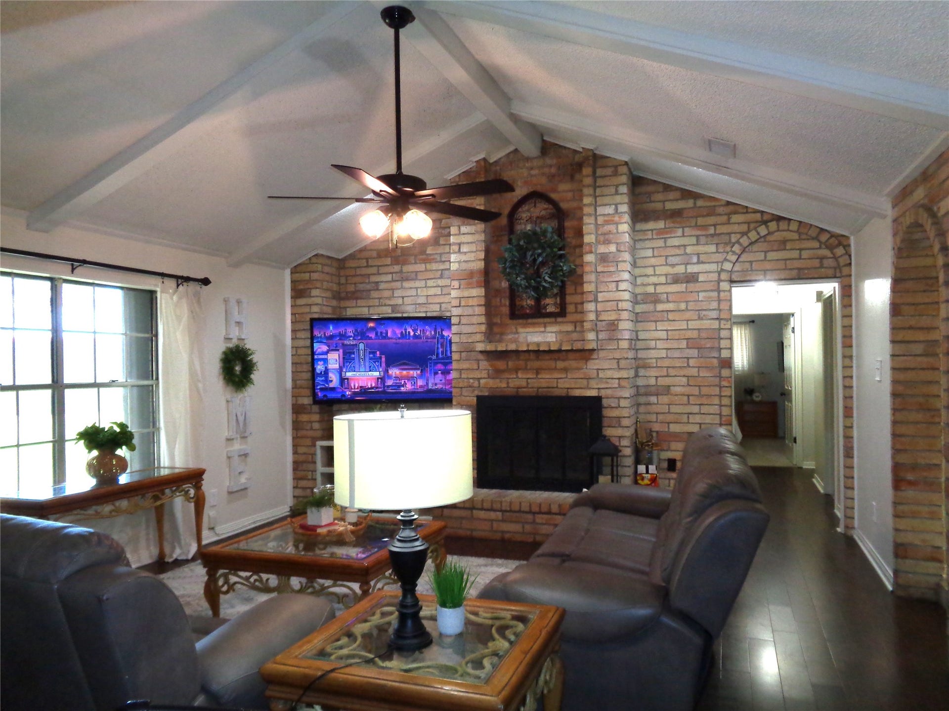 2502 20th Street N, Texas City, TX 77590 Family room with wood burning fireplace and vaulted ceiling.