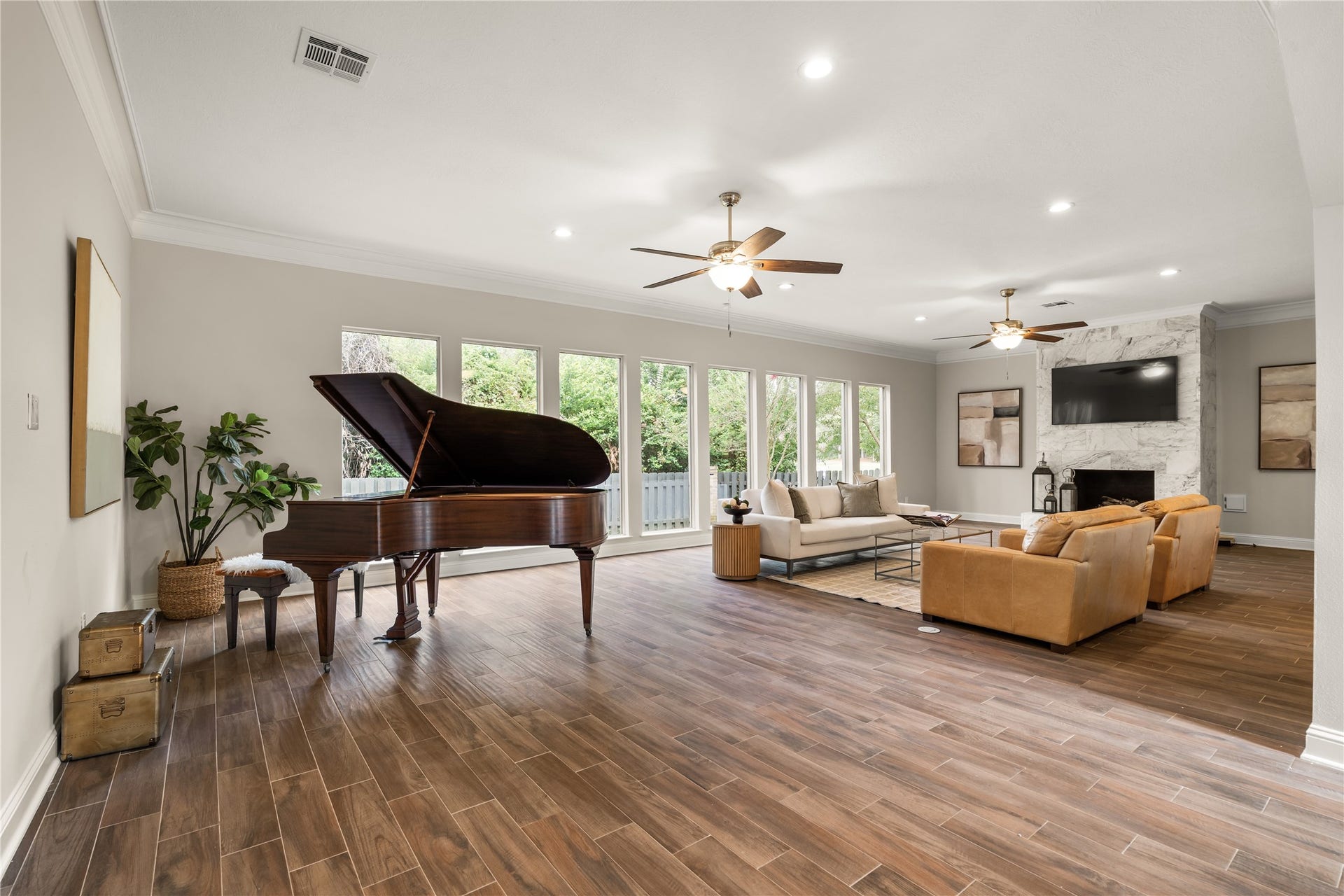 4719 Breezy Point Drive, Houston, TX 77345 Anchored by a distinguished 1914 Chickering & Sons quarter grand piano, this expansive living space offers an elegant setting for entertaining, intimate gatherings, and memorable evenings at home.