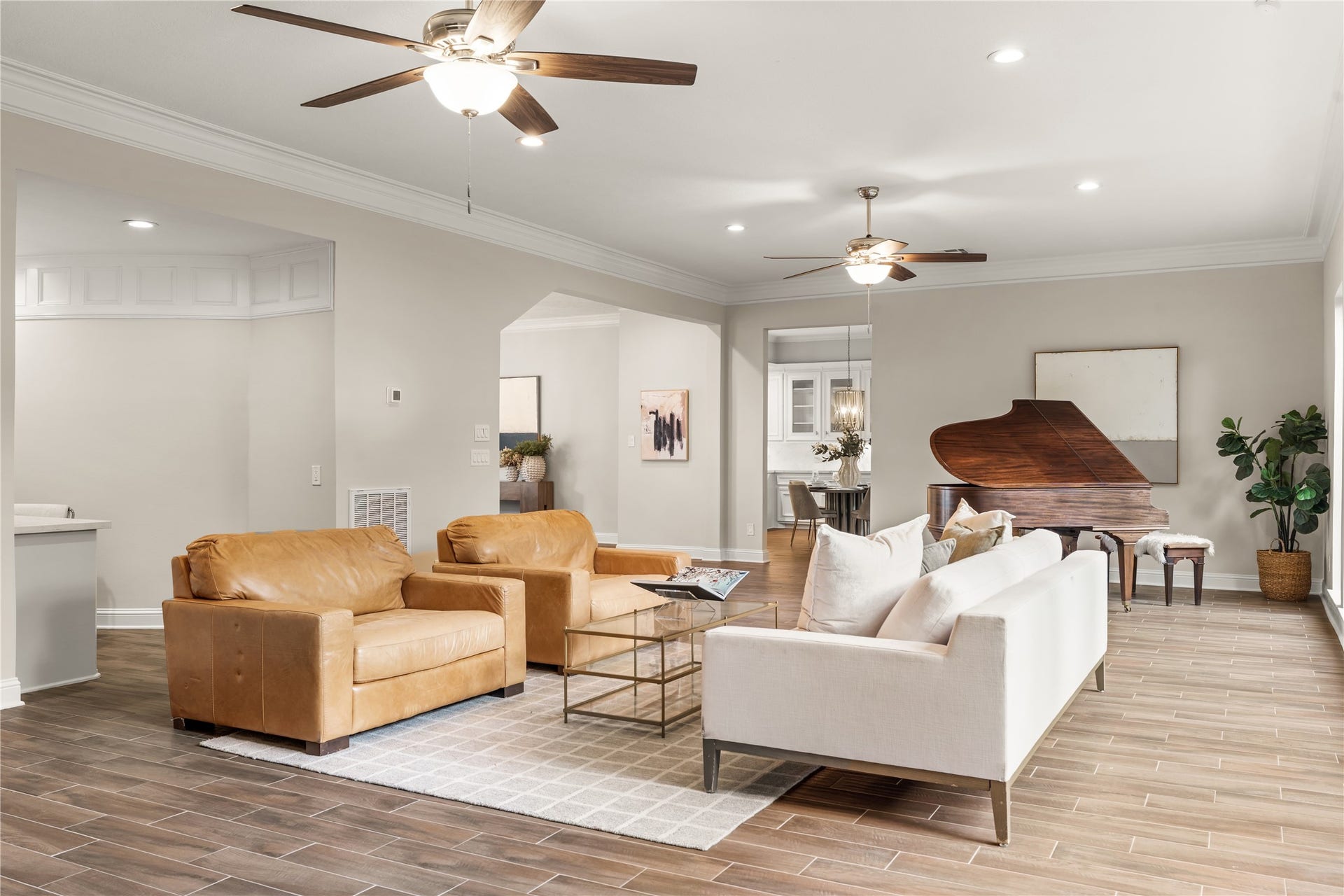 4719 Breezy Point Drive, Houston, TX 77345 The open-concept layout creates an effortless flow between the homes gathering spaces, while a thoughtfully positioned office nook in the corner adds a discreet and functional workspace without interrupting the rooms elegant design.