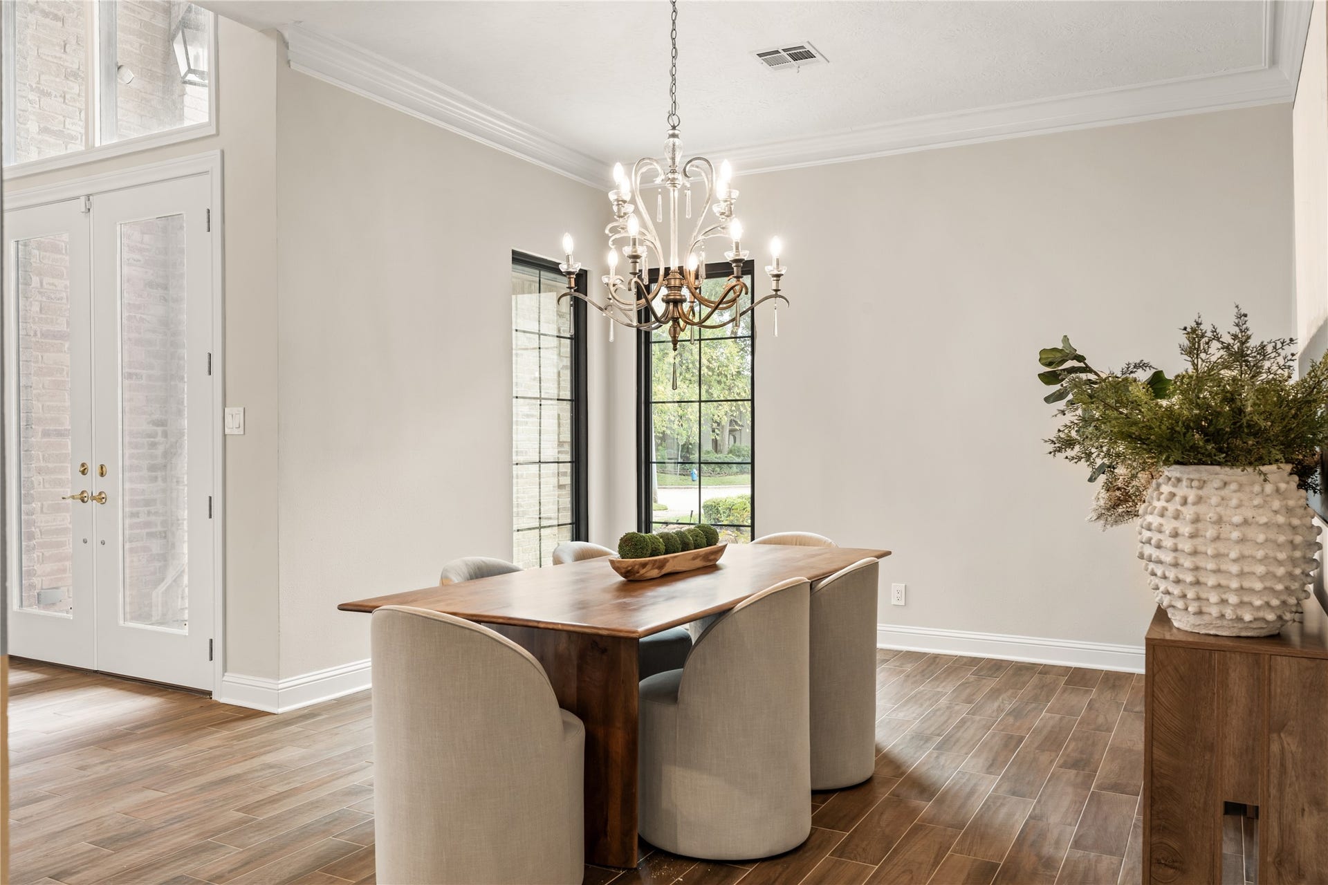 4719 Breezy Point Drive, Houston, TX 77345 Refined yet inviting, the formal dining room pairs warm wood tones, elegant lighting, and tall windows for a sophisticated entertaining setting.