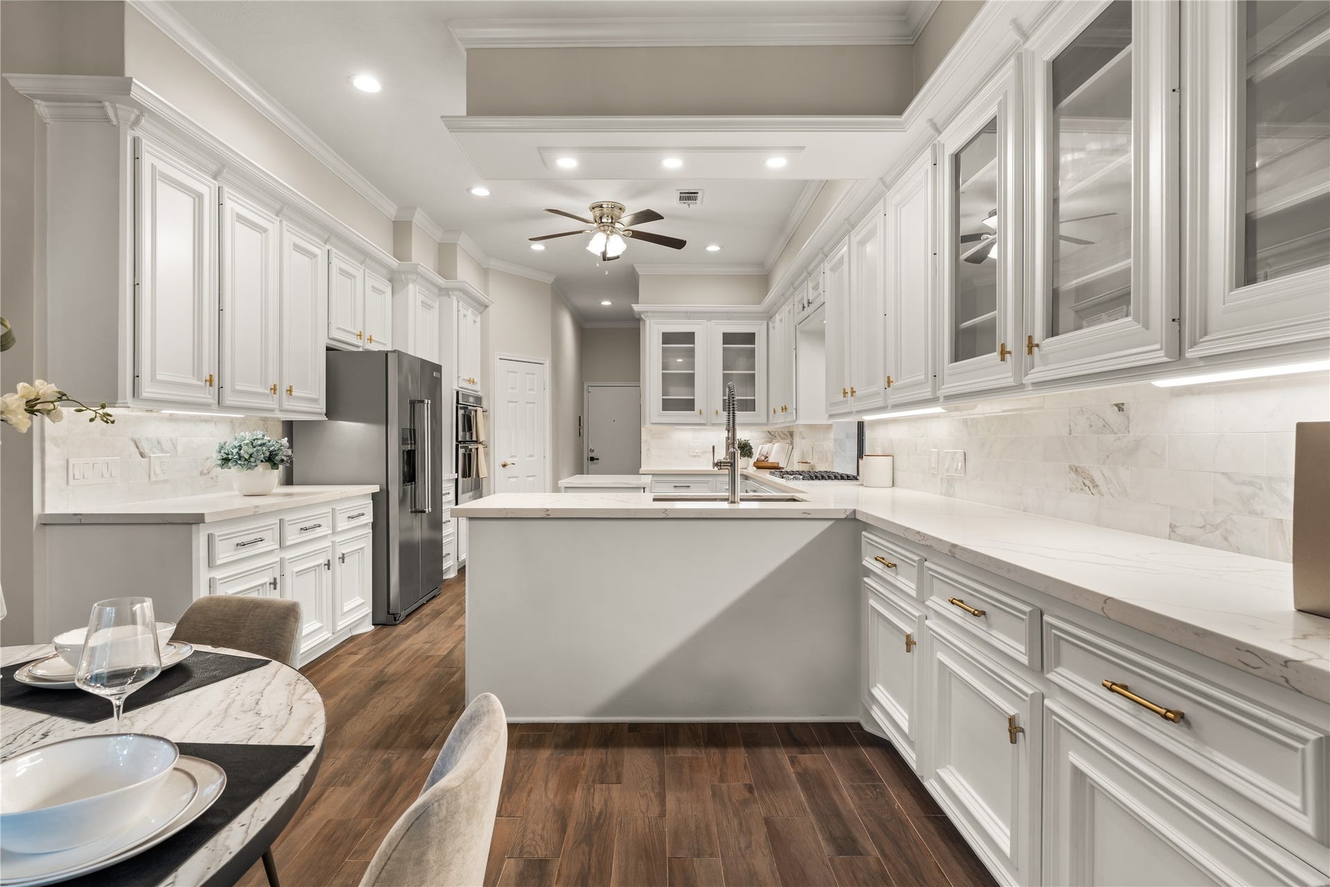 4719 Breezy Point Drive, Houston, TX 77345 Crisp white cabinetry creates a bright, timeless aesthetic, while an abundance of storage and generous counter space offers exceptional functionality for both everyday living and entertaining.