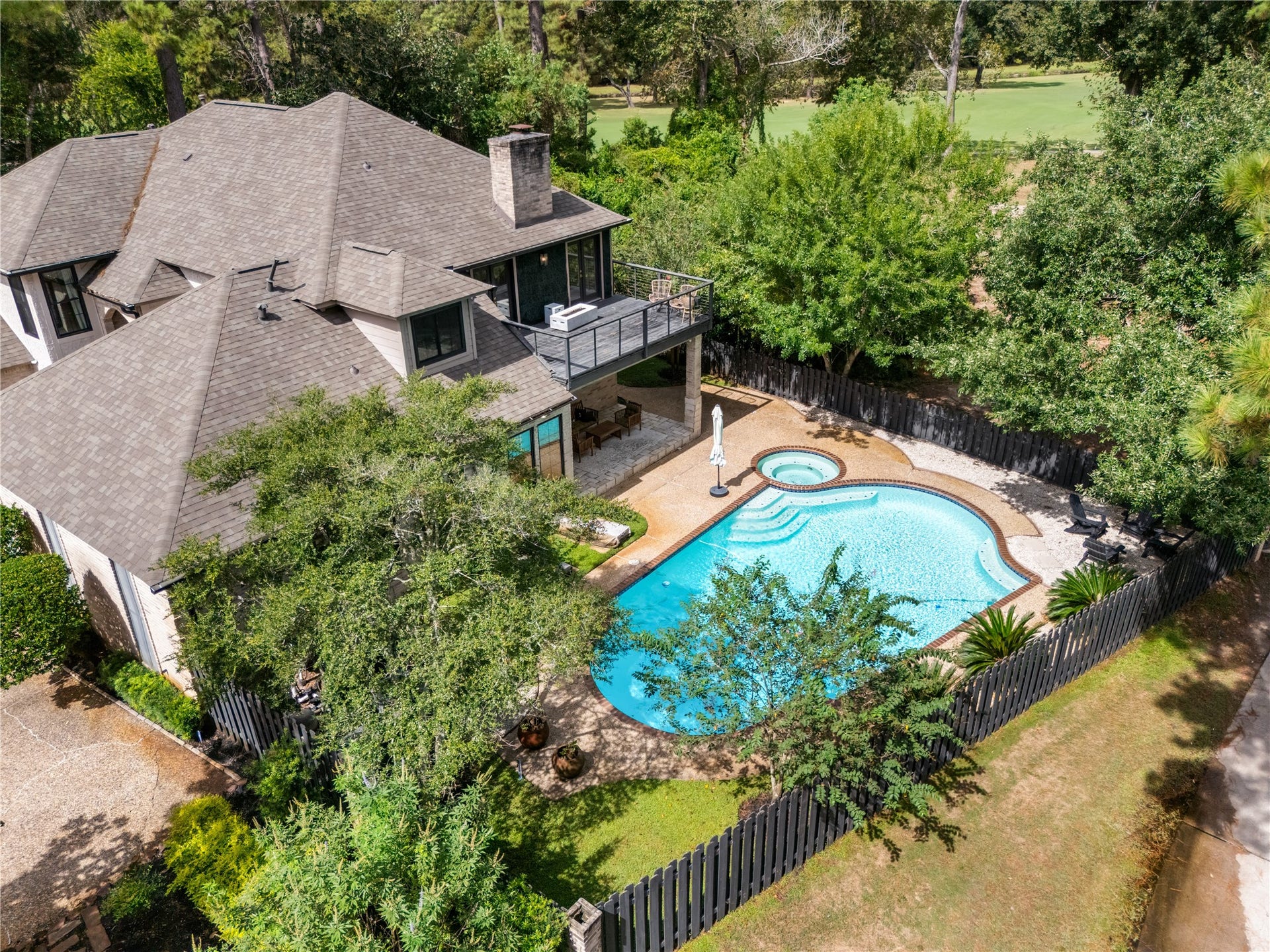 4719 Breezy Point Drive, Houston, TX 77345 The backyard flows directly to the Deerwood Country Club golf course, creating a coveted setting where private outdoor living meets the beauty of the fairways. The pool, spa, covered patio, and elevated terrace make the most of this exceptional golf-course location