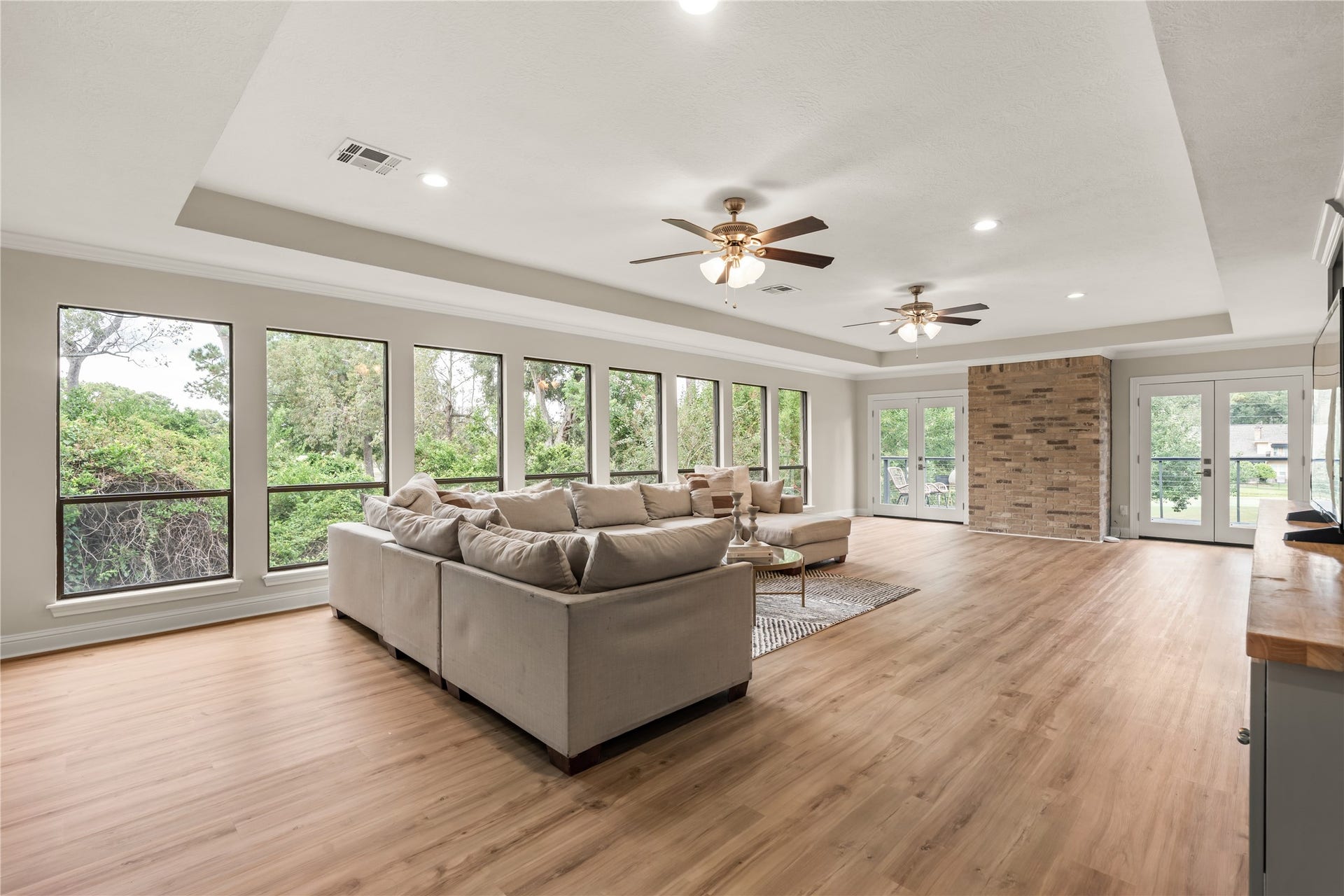 4719 Breezy Point Drive, Houston, TX 77345 An impressive upstairs family room is wrapped in natural light and treetop views, with updated LVP flooring creating a polished setting for relaxing or entertaining.