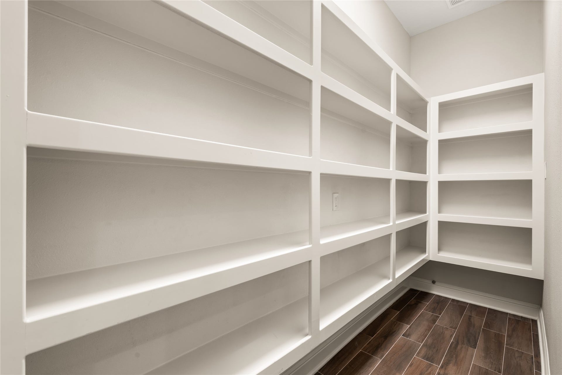 4719 Breezy Point Drive, Houston, TX 77345 A spacious walk-in pantry offers exceptional storage with extensive built-in shelving, keeping everyday essentials beautifully organized.