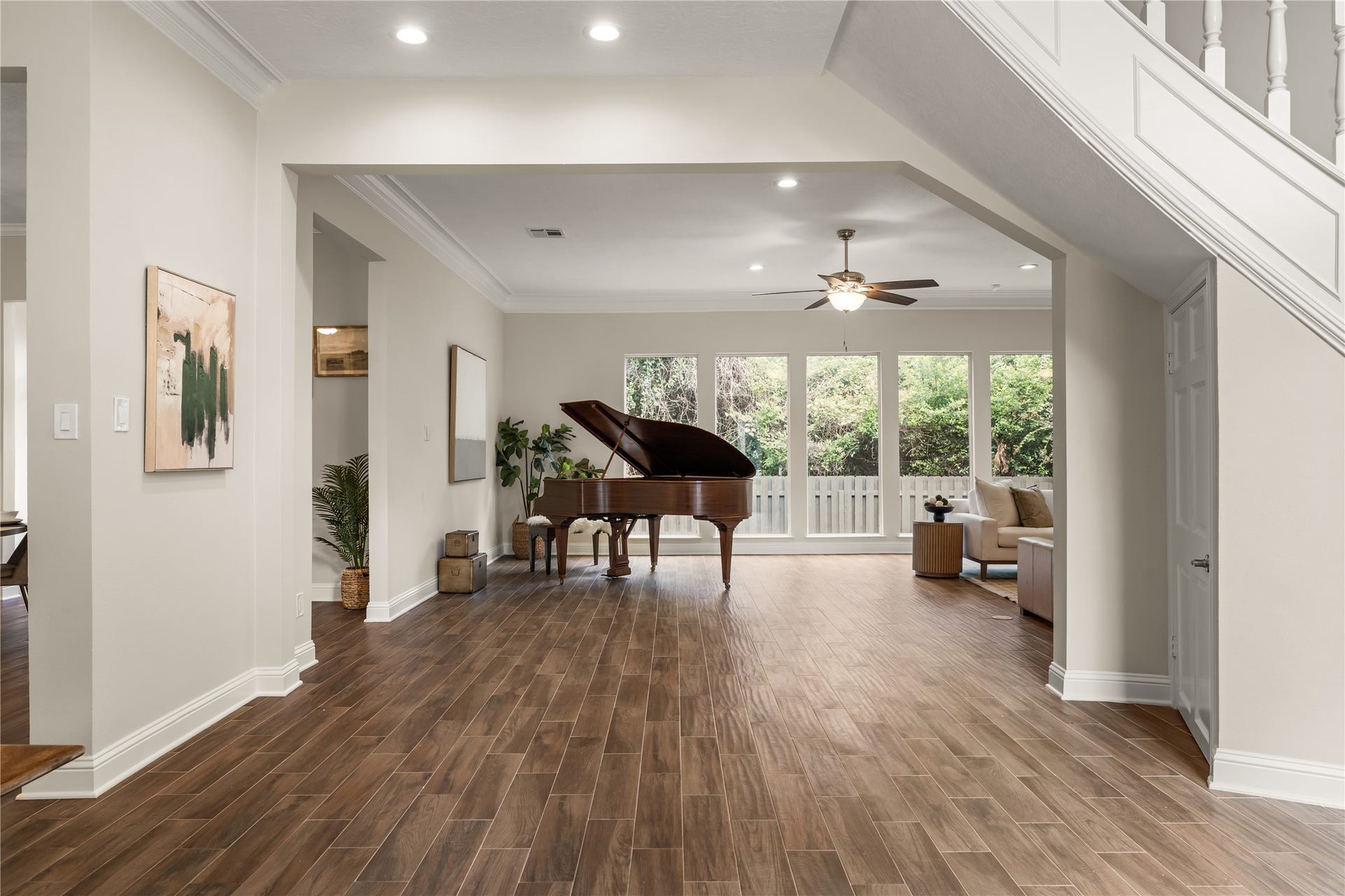 4719 Breezy Point Drive, Houston, TX 77345 The elegant foyer opens gracefully into the expansive living room, where soaring proportions, abundant natural light, and a grand piano create a sophisticated sense of arrival.