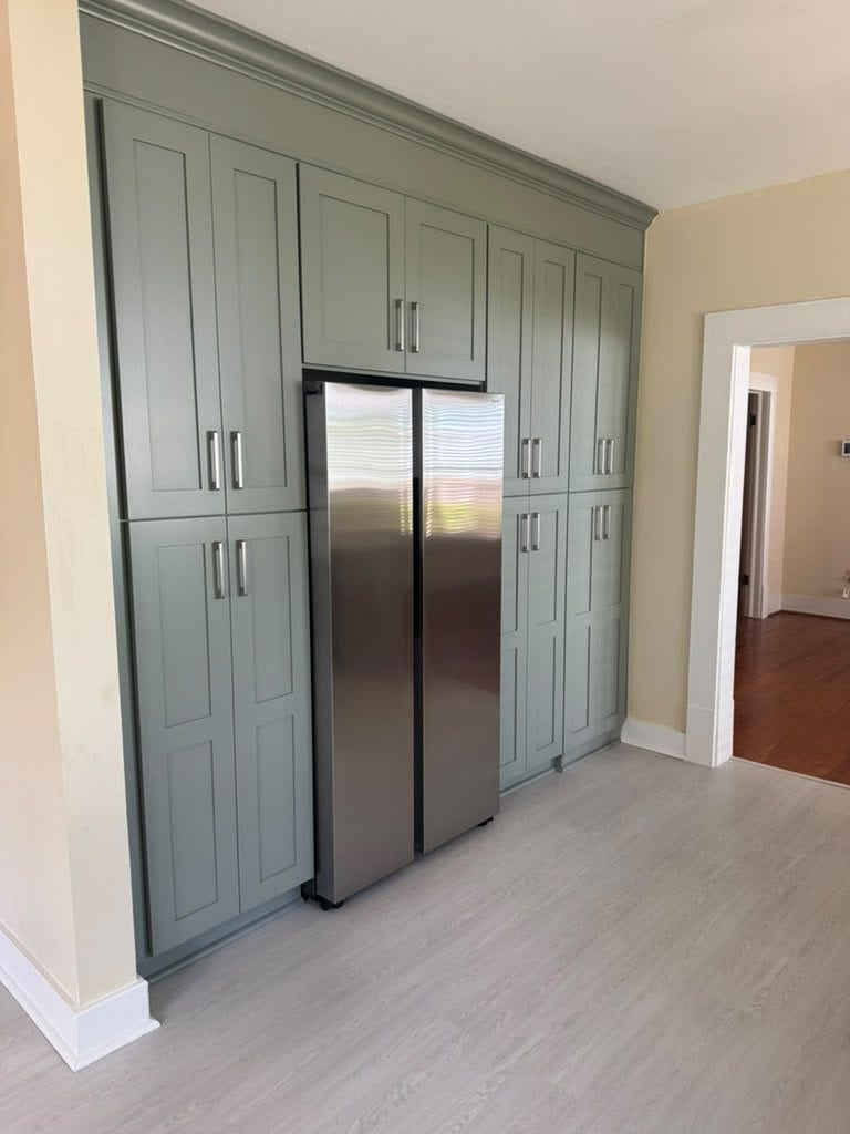 The refrigerator is surrounded by a wall of storage