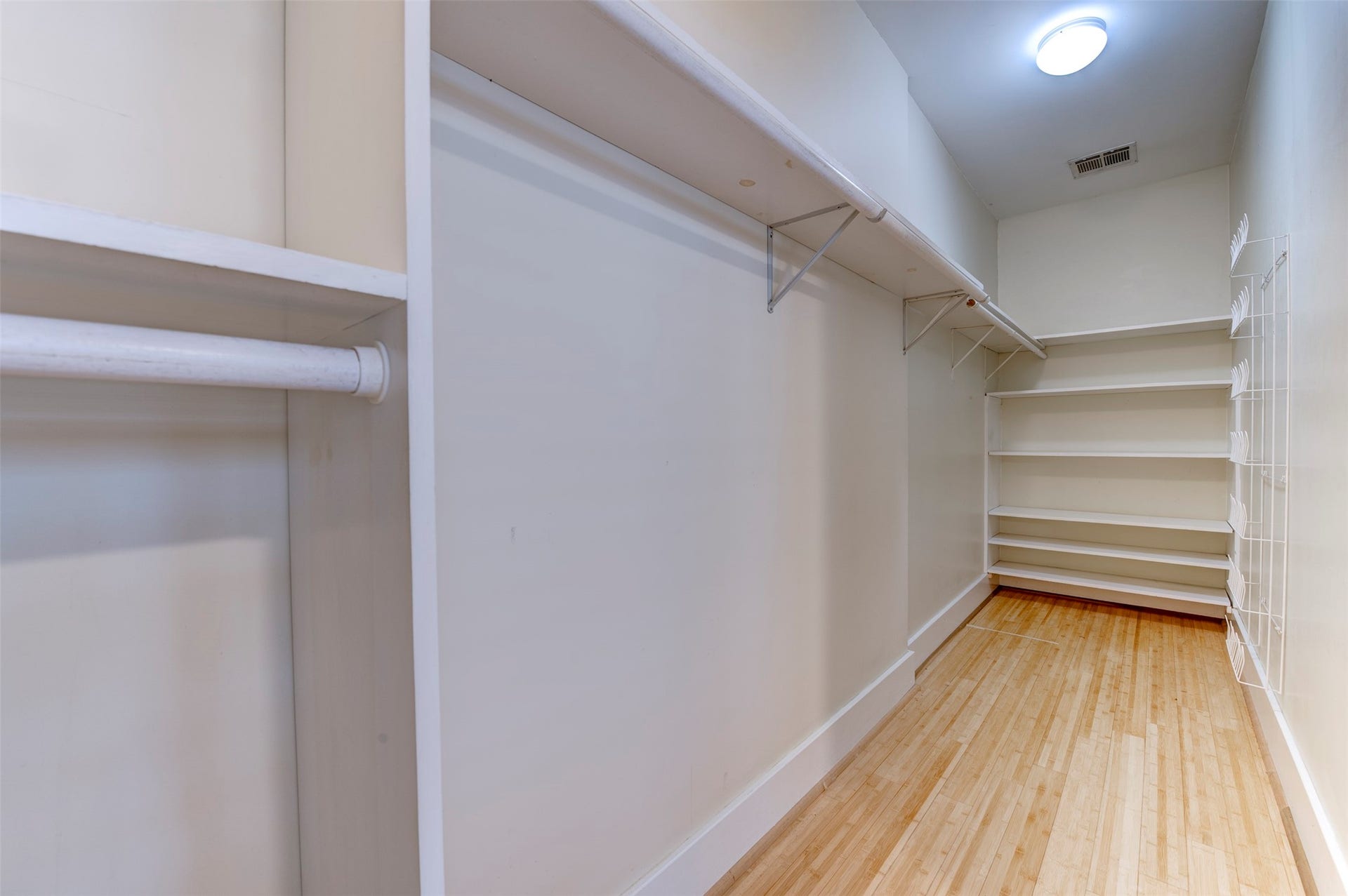 The primary bedroom has one of the two walk-in closets in the ehome.