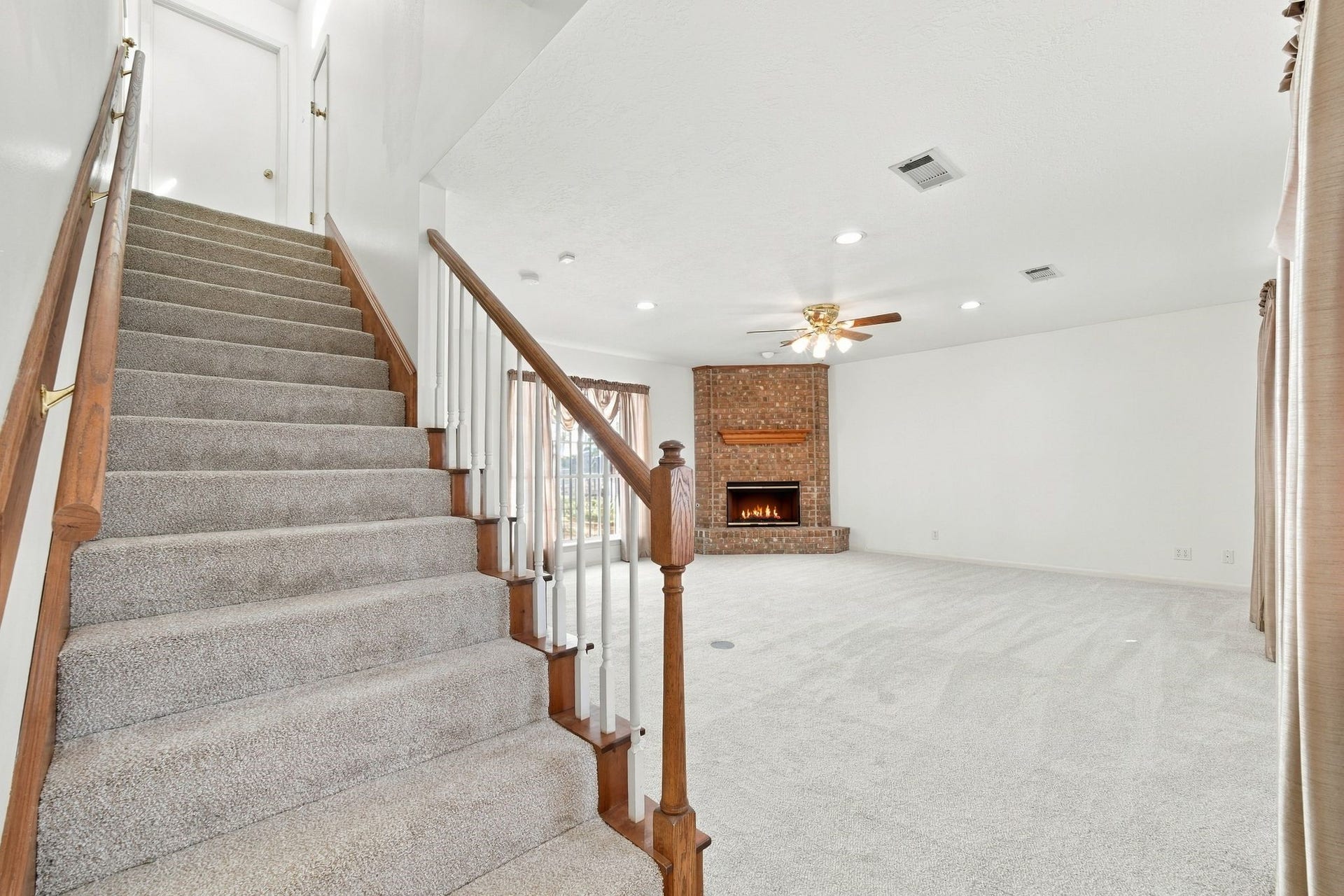 5125 Nina Lee Lane, Houston, TX 77092 Bright and spacious room with plush carpeting, abundant natural light from multiple windows, and a ceiling fan for comfort.