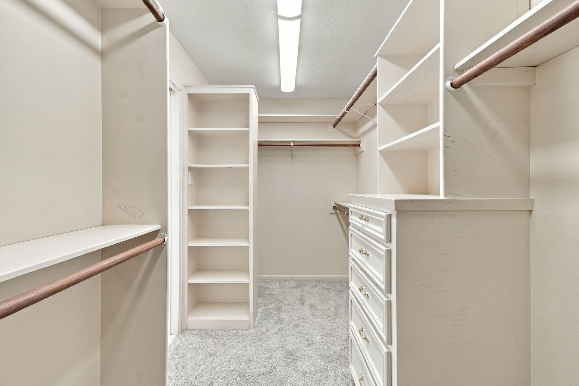 5125 Nina Lee Lane, Houston, TX 77092 Expansive walk-in closet with abundant shelving, hanging space, and built-in drawers for seamless organization.