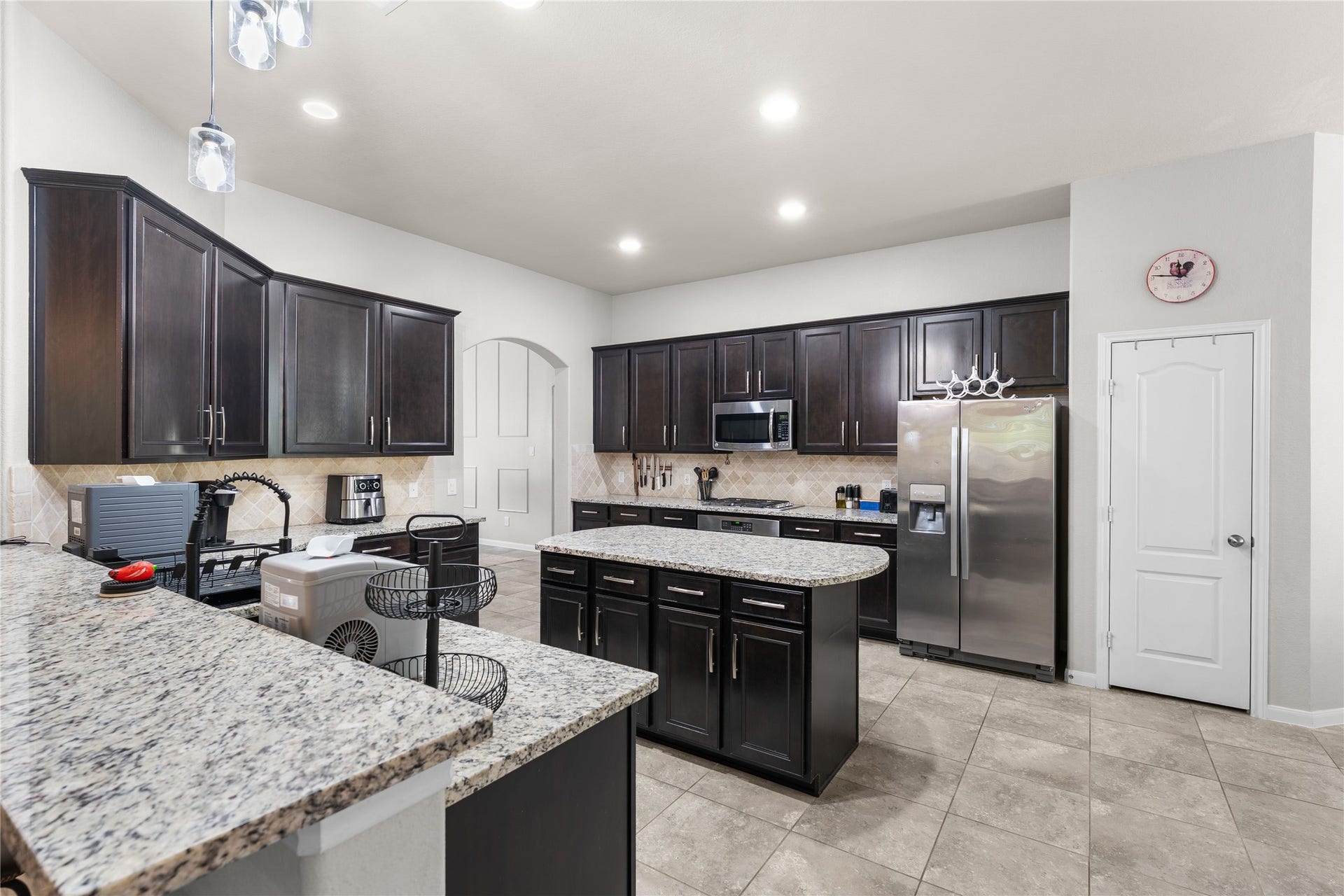 Granite island kitchen with abundant cabinetry and modern finishes.