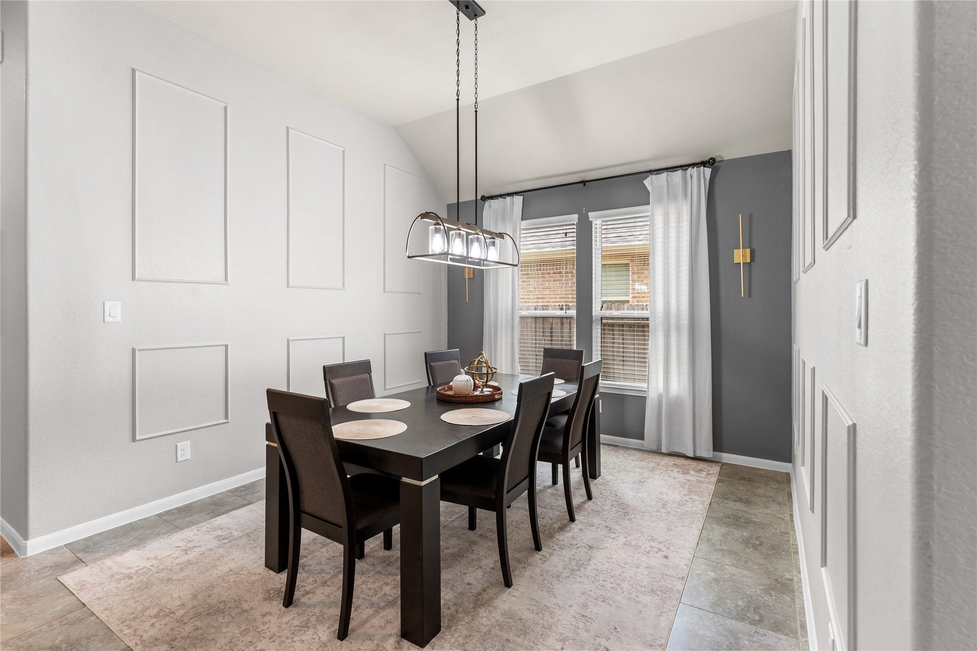 Dining area with decorative wall accents and easy access to the kitchen.