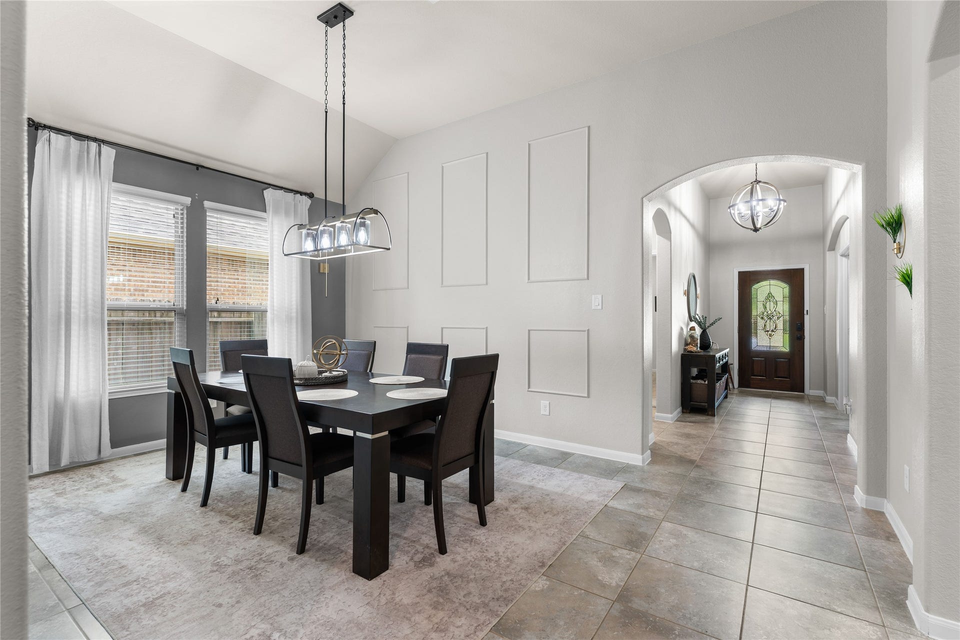 Bright formal dining room with natural light and elegant finishes for everyday meals or entertaining.
