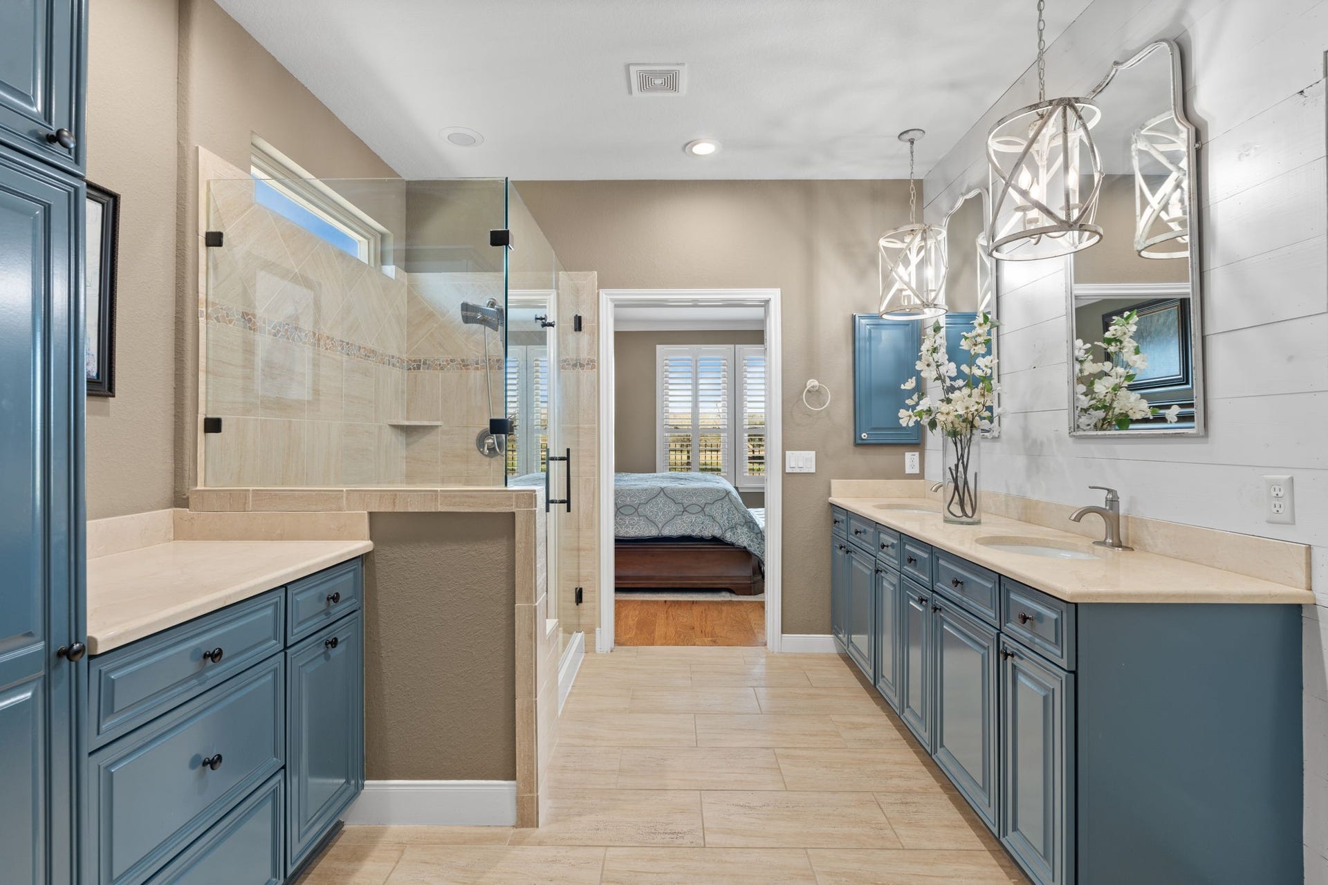 Start and end your day in an owner's bathroom designed for both relaxation and inspiration. Thoughtfully crafted for comfort, this space features a convenient medicine cabinet and stunning French blue custom-painted cabinetry. A unique pull-out trash adds both style and functionality to this elegant retreat.