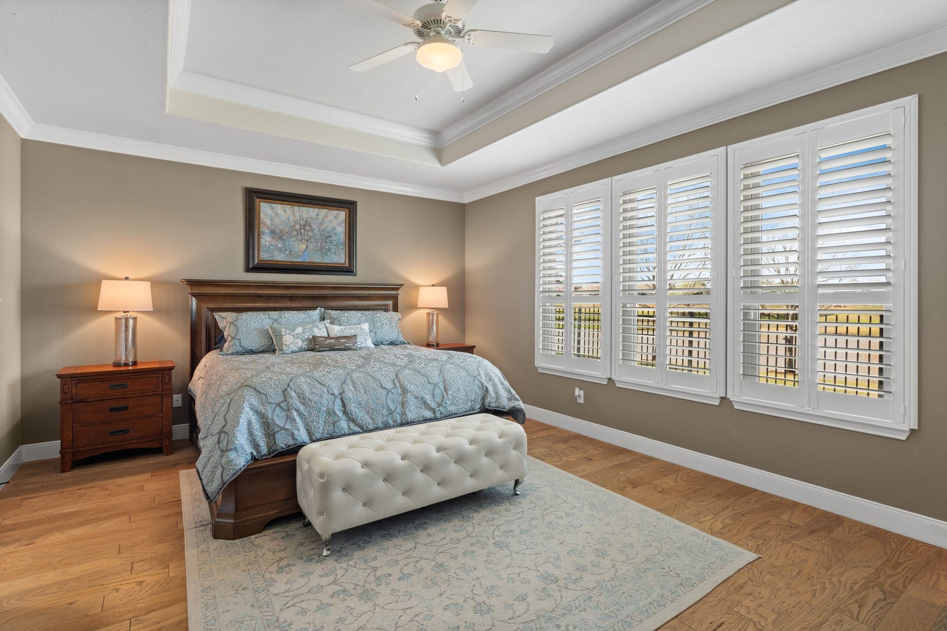 Step into the owner's suite, a space that exudes luxury and comfort. This expansive room boasts a tray ceiling adorned w/crown molding.