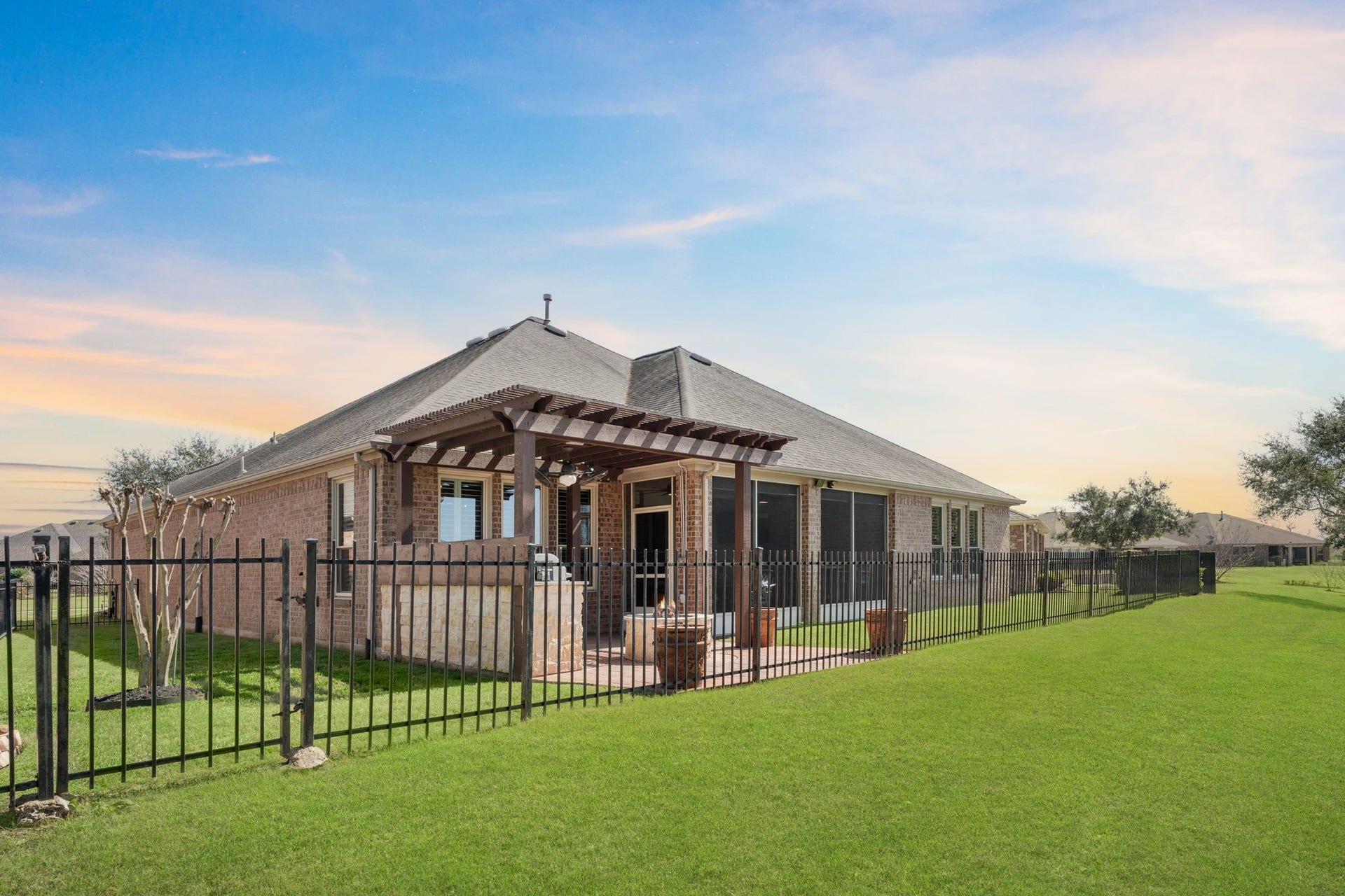 Shaded by a custom-made pergola, this patio is designed for comfort and style.