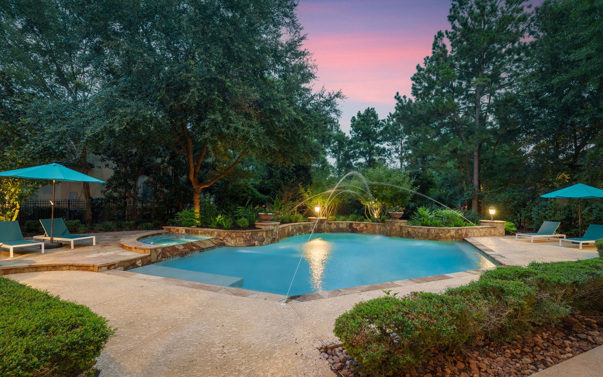 39 N Palmiera Circle, The Woodlands, TX 77382 Custom pool (updated w/ pebbletech) spa with water features is surrounded by mature landscape for privacy.