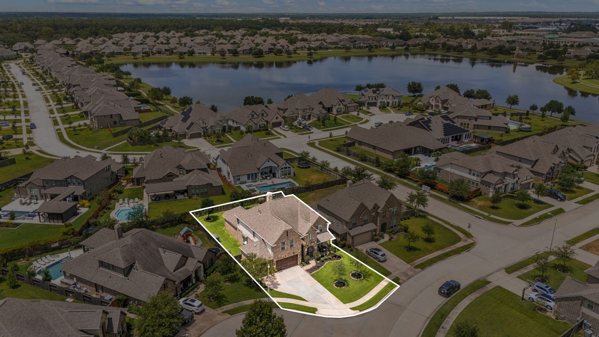 13522 Columbia Key Drive, Tomball, TX 77377 This aerial perspective shows the homes location within the community, with the outlined lot offering a clear view of its proximity to the neighborhood pond.