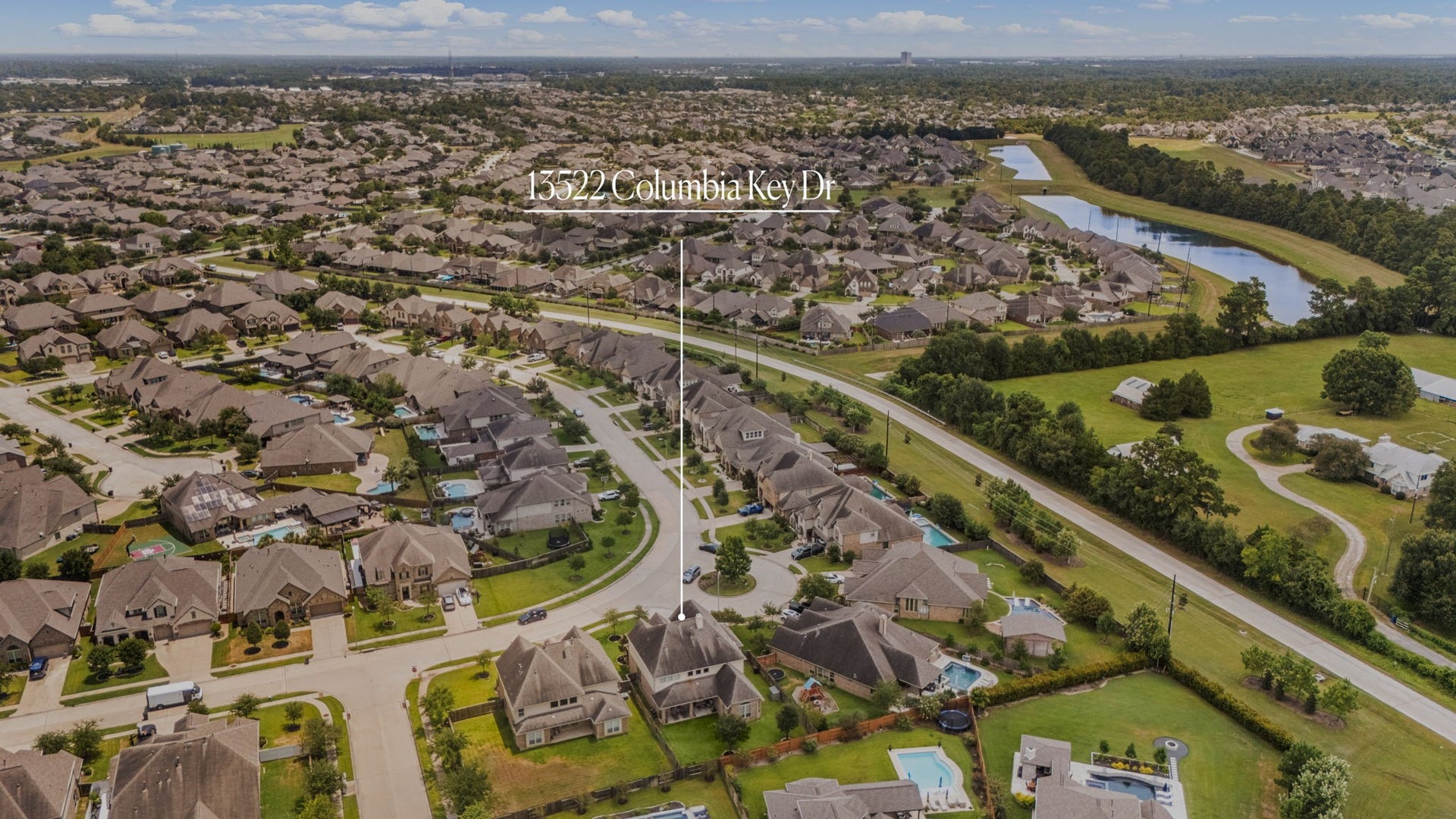 13522 Columbia Key Drive, Tomball, TX 77377 From this rear aerial perspective, 13522 Columbia Key Drive is clearly identified while also showcasing its position within the surrounding neighborhood and larger community setting.