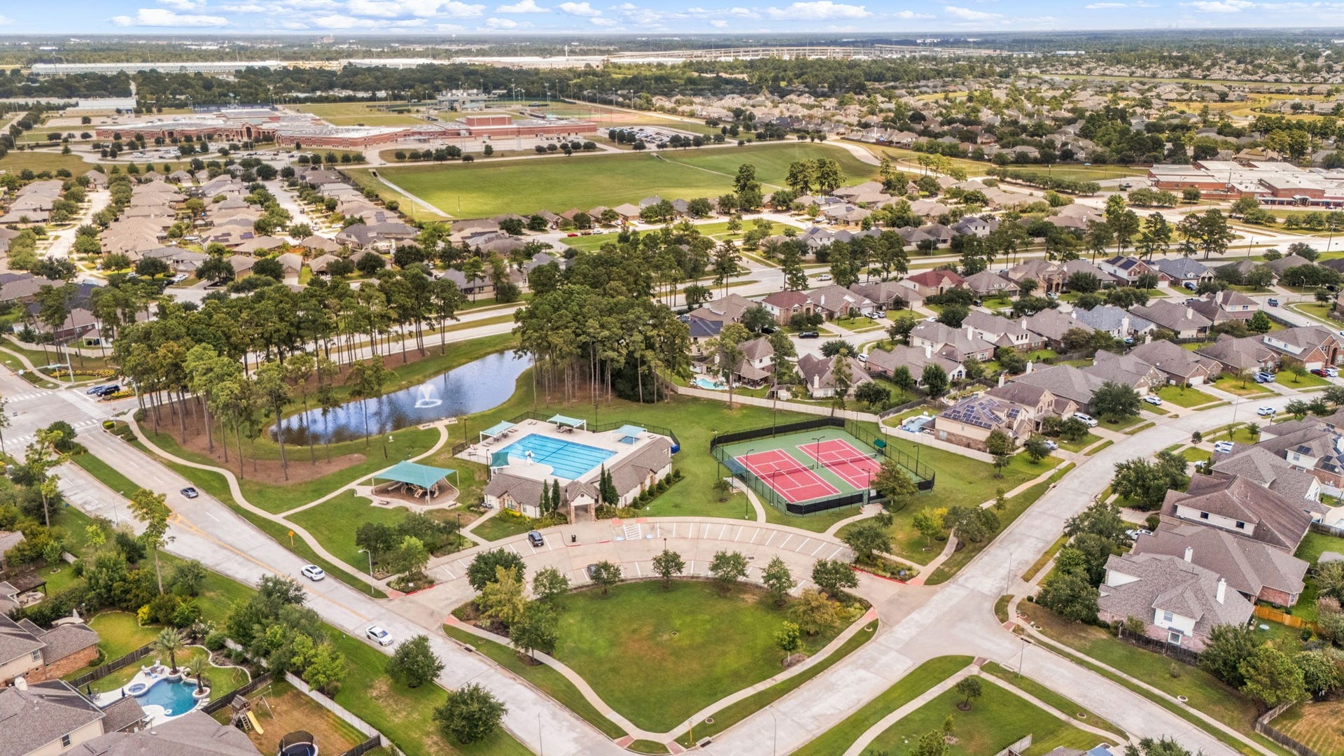 13522 Columbia Key Drive, Tomball, TX 77377 From above, the community amenities come into view, including tennis courts, pool, pond, covered playground, and convenient nearby parking.
