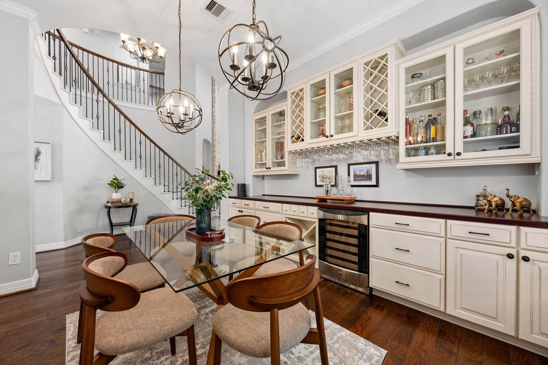 13522 Columbia Key Drive, Tomball, TX 77377 Positioned near the front of the home, the dining room offers an easy connection to the main living areas, with a glimpse of the staircase and built-in bar cabinetry adding both function and character.