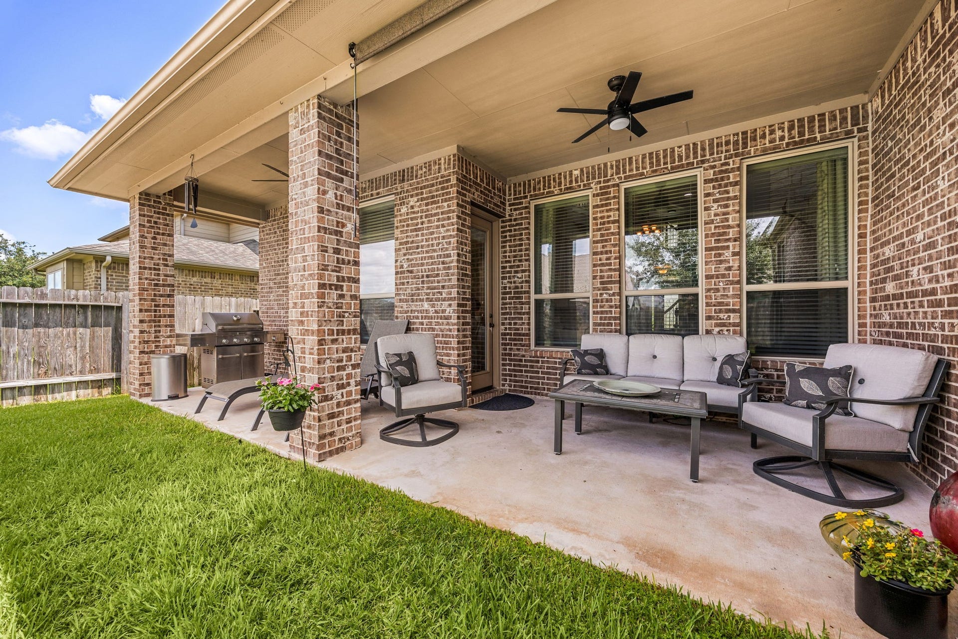 13522 Columbia Key Drive, Tomball, TX 77377 A covered back patio with ceiling fan offers the perfect setting for outdoor dining, grilling, and relaxed lounging.