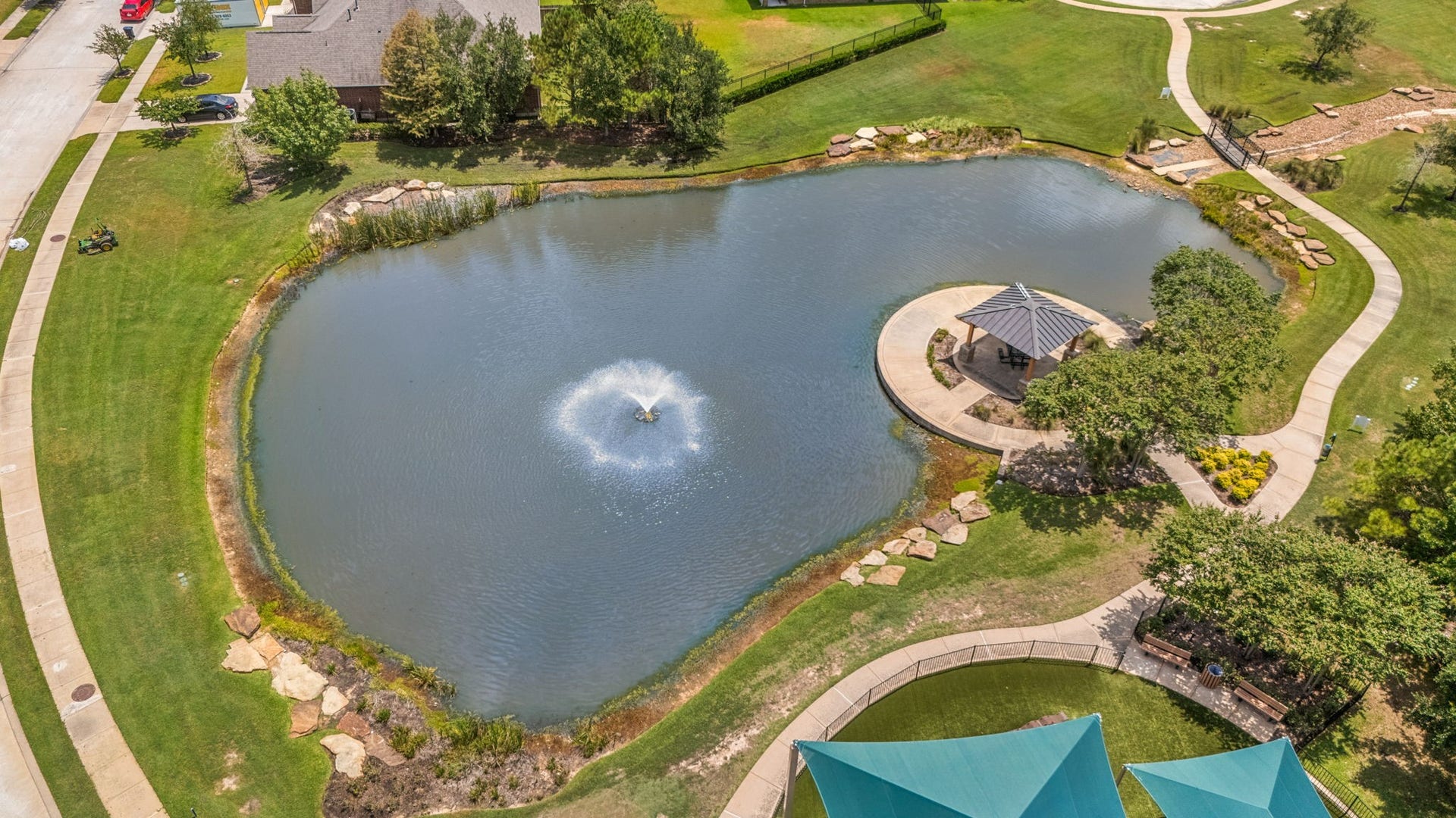 13522 Columbia Key Drive, Tomball, TX 77377 A scenic pond with fountain, surrounding sidewalk, and shaded gazebo offers a peaceful place to walk, relax, or enjoy the outdoors.