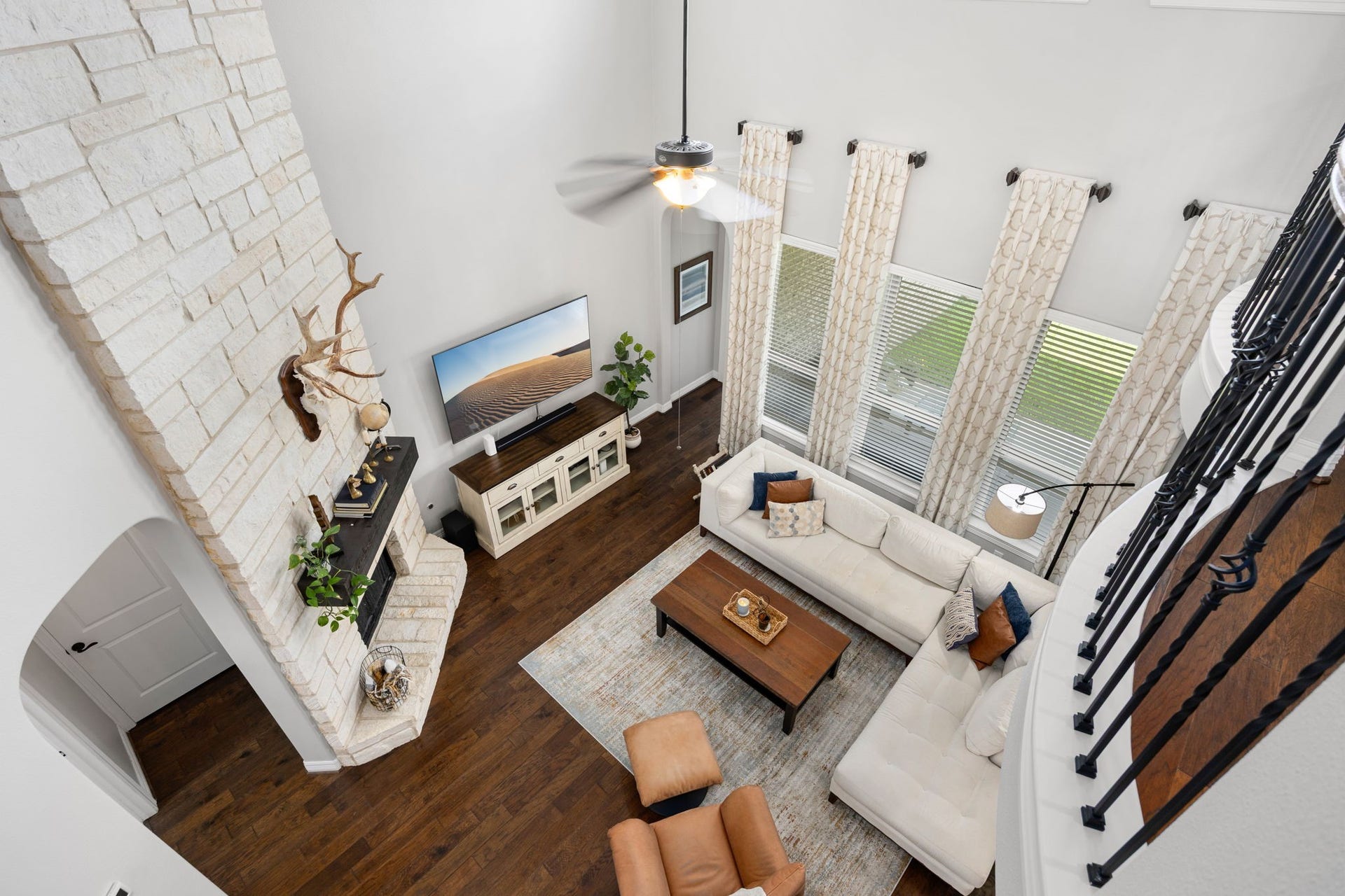 13522 Columbia Key Drive, Tomball, TX 77377 From the upstairs landing, this view looks down into the main living area, highlighting the homes soaring ceilings and the open connection between the first-floor living space and second-floor flex areas.