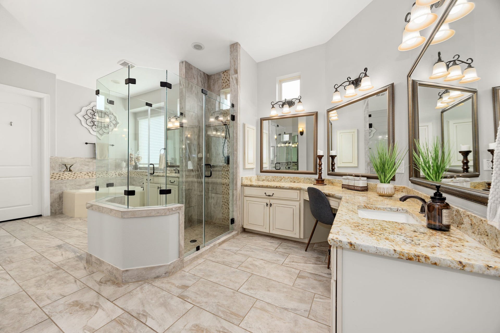 13522 Columbia Key Drive, Tomball, TX 77377 An expansive primary bathroom with wraparound vanity space, generous counter areas, a corner soaking tub, and a large glass shower with access from both sides.