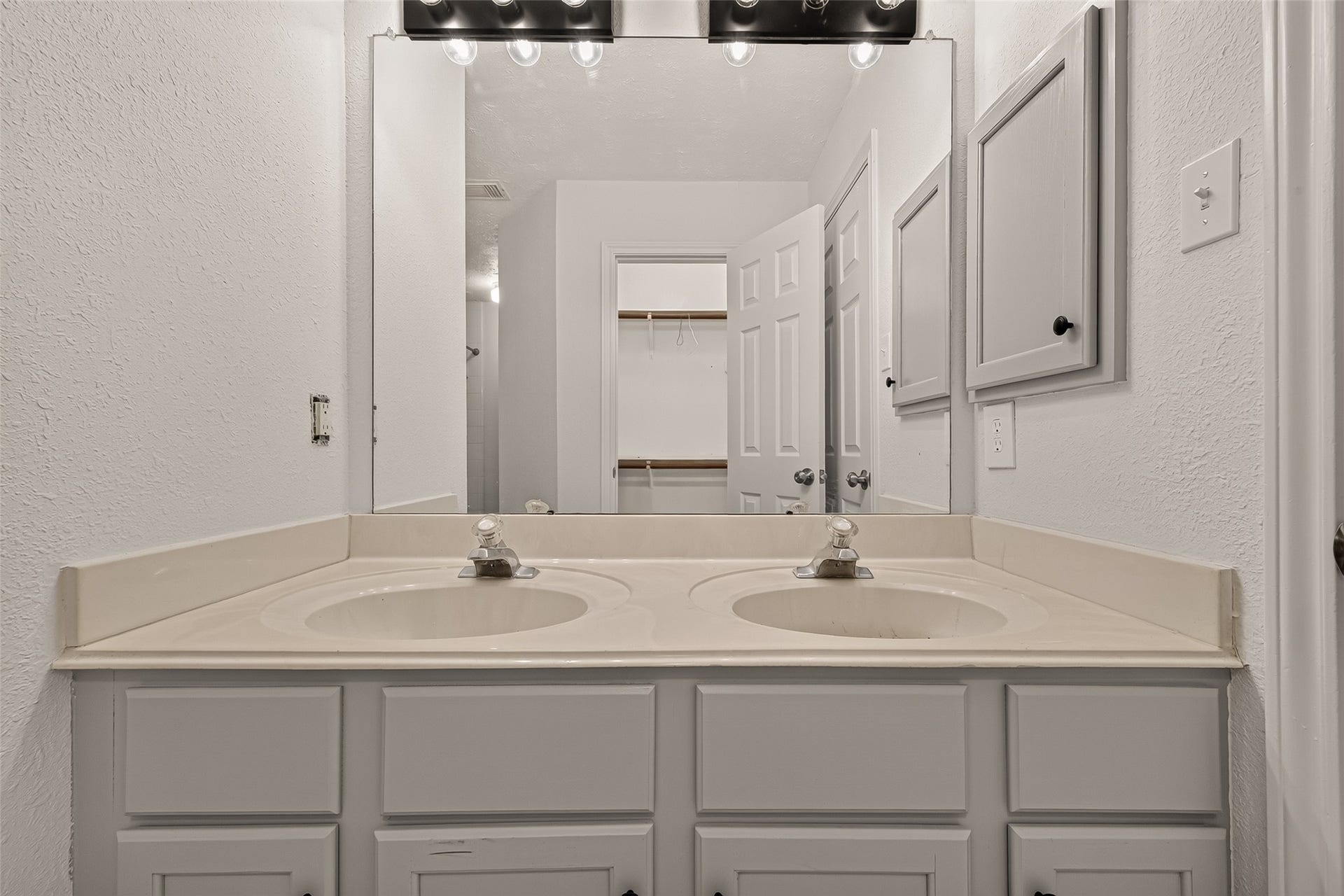 3356 Rachel Lane, Katy, TX 77493 Primary double sink, and a view of the primary closet in the mirror.