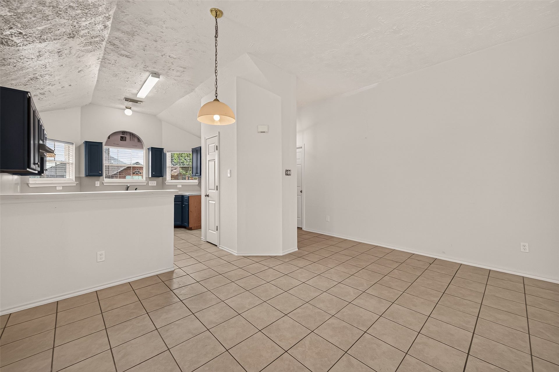 3356 Rachel Lane, Katy, TX 77493 Three windows allowing a lot natural light from sunsets into the home. Kitch pantry is visible.