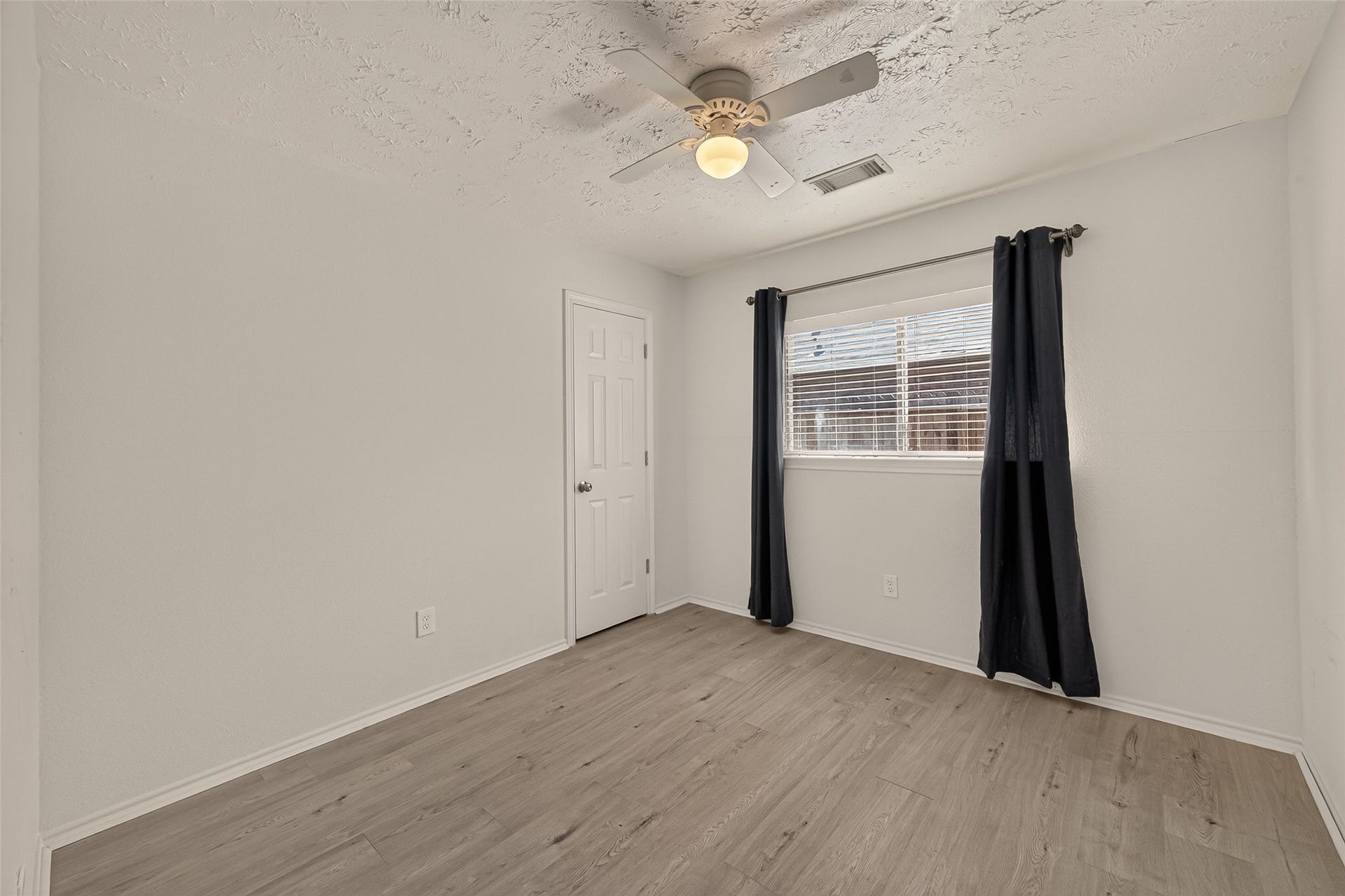 3356 Rachel Lane, Katy, TX 77493 The first bedroom off the hallway way is a great space for an office or a bedroom with laminate flooring. This room also offers a nice sized closet.
