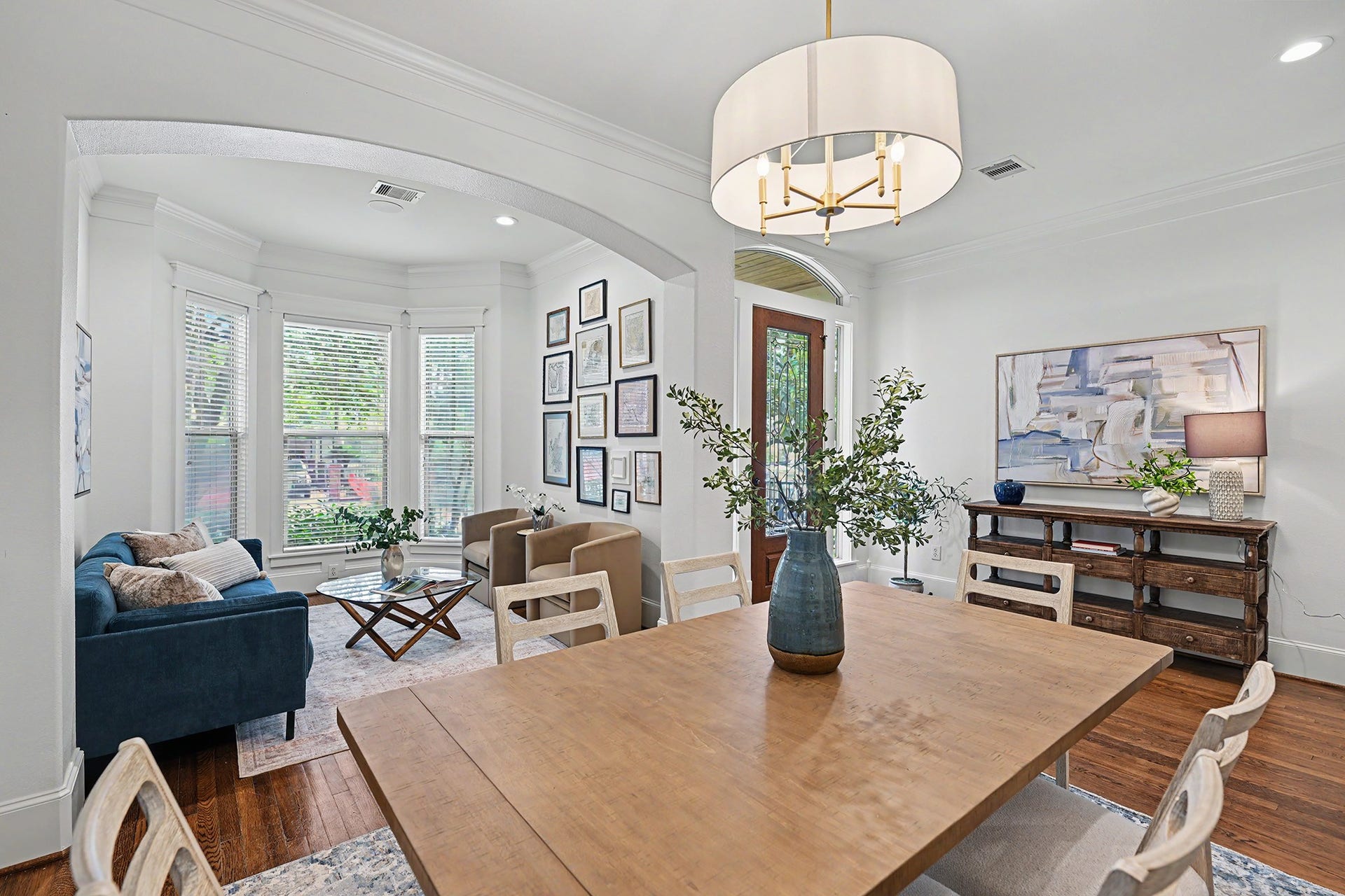 Overall view of the front dining/living with striking light fixture.