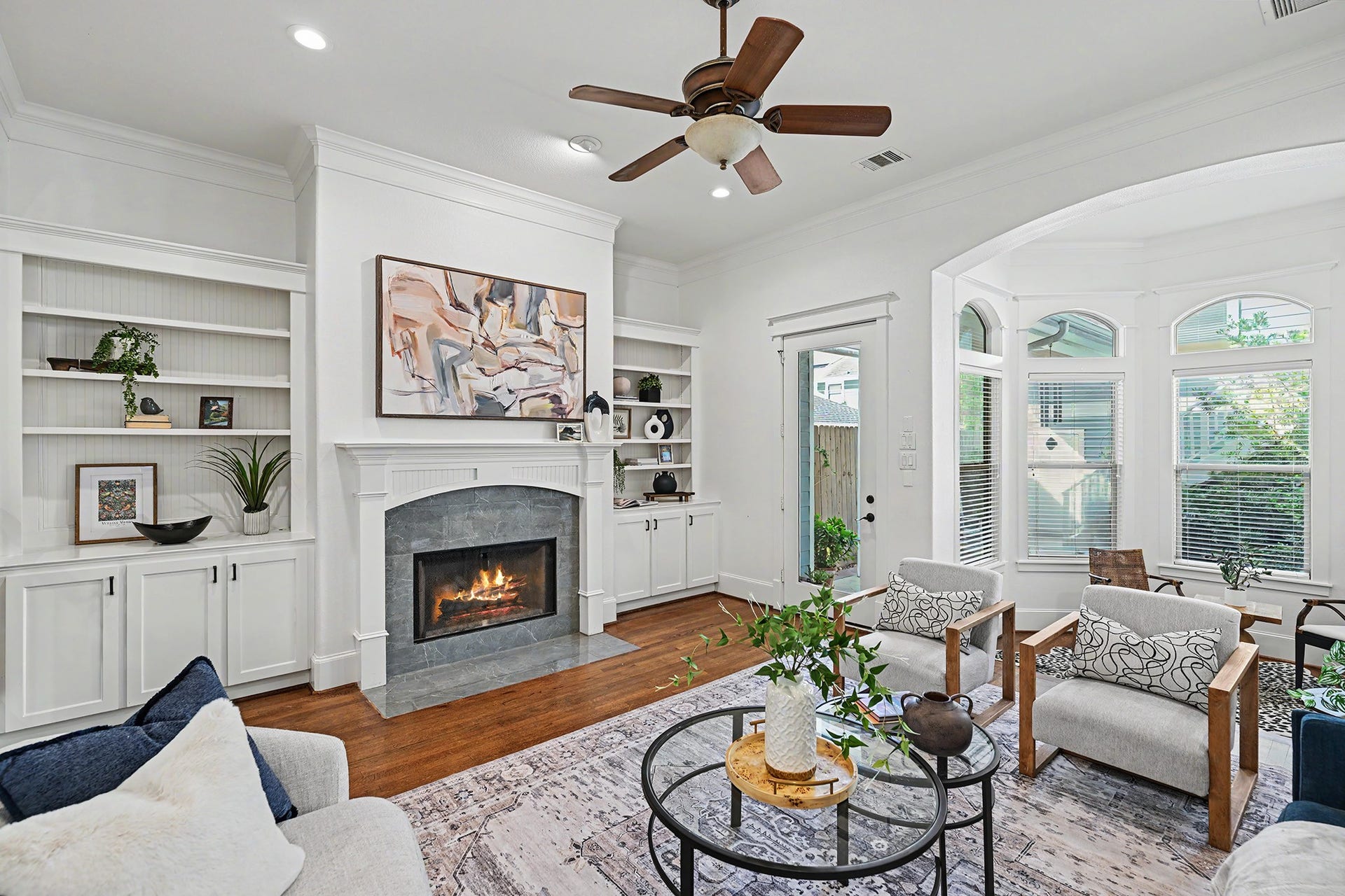Spacious and relaxing family room area. Side storage and bookshelves flank the fireplace.