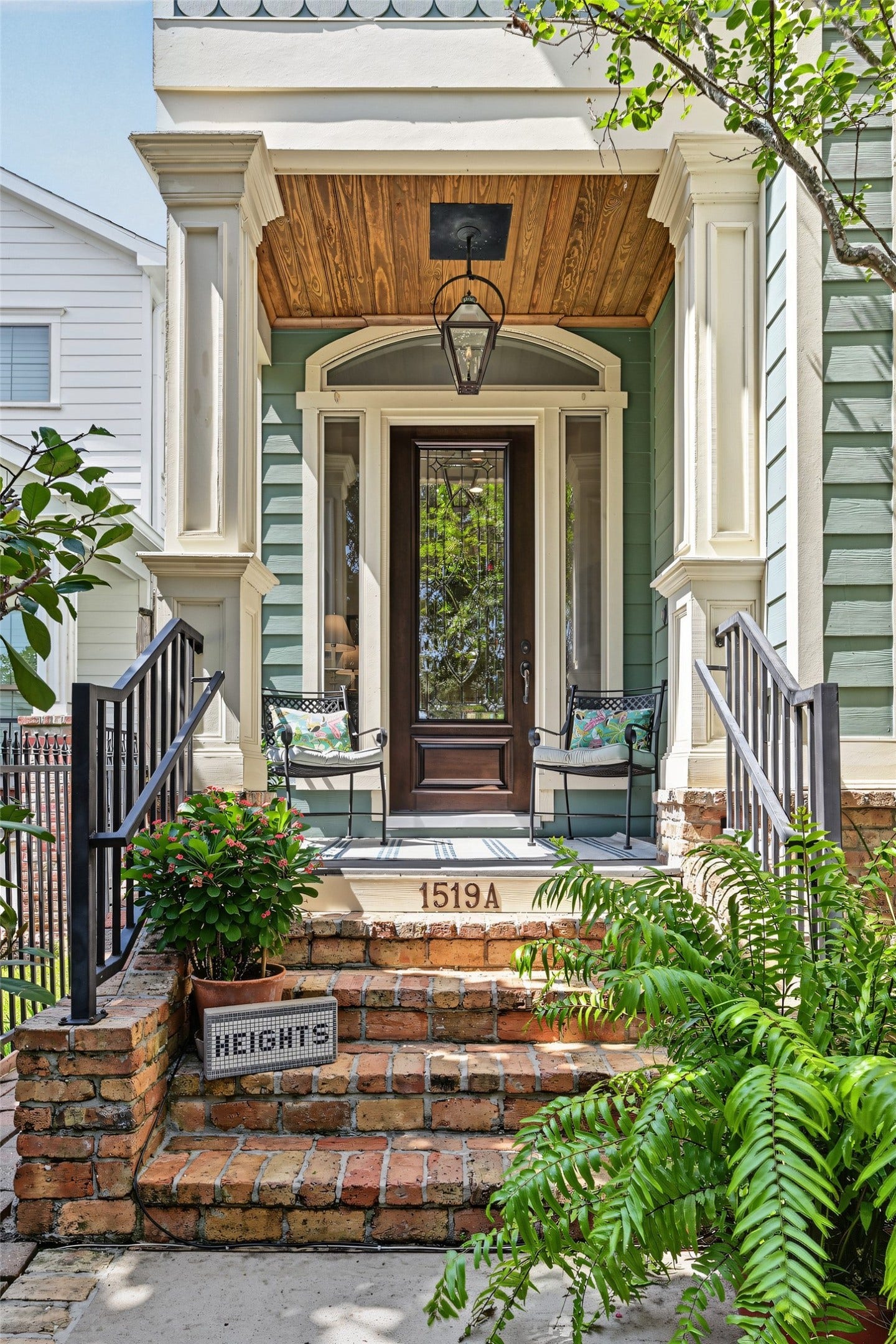 Inviting front entry with brick steps and gas lantern.