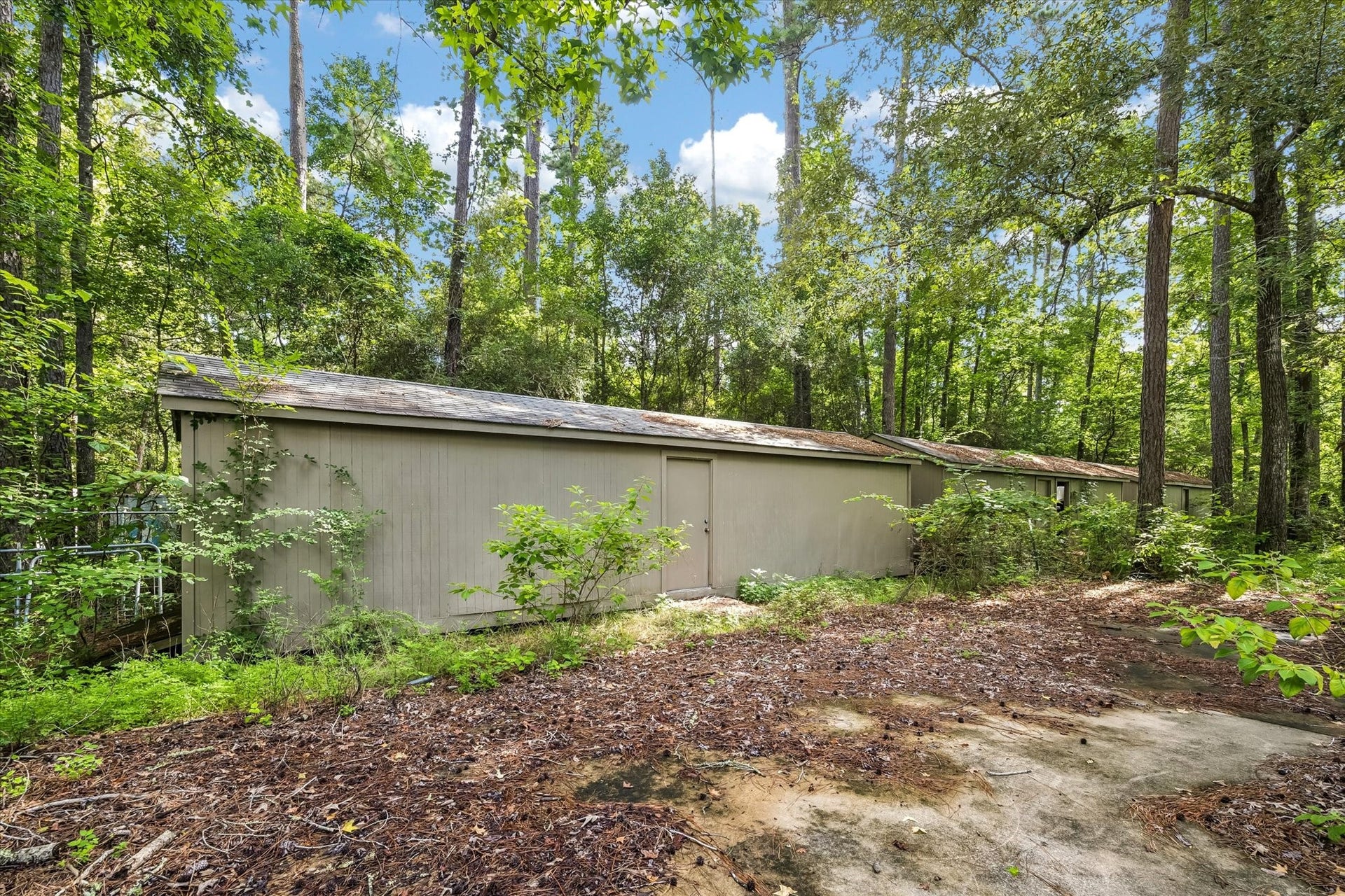 226 S Pine Drive, Montgomery, TX 77356 Additional storage building tucked beneath the mature tree canopy, conveniently located next to the main residence.