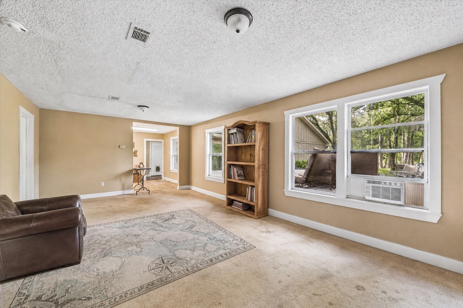 226 S Pine Drive, Montgomery, TX 77356 This reverse view reveals the rooms elongated layout and connection to the adjoining spaces. A wide picture window draws the outdoors into the seating area.