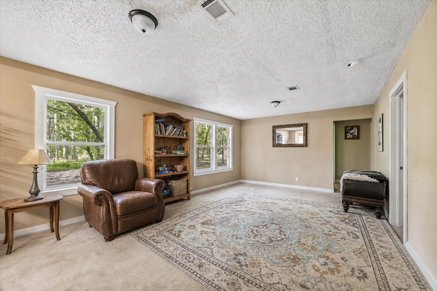 226 S Pine Drive, Montgomery, TX 77356 Windows on adjoining walls bring garden views into this separate living space. Its broad seating area offers room to spread out away from the main gathering room.