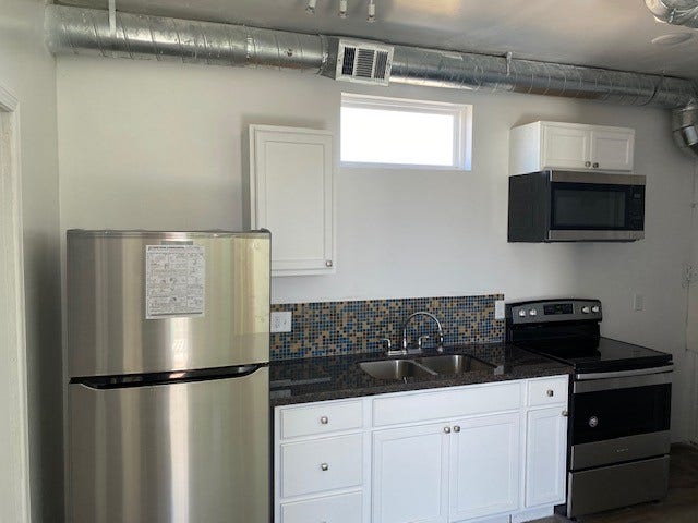 3601 Princeton, Galveston, TX 77554 Kitchen in duplex unit 1 with granite countertops and SS appliances.