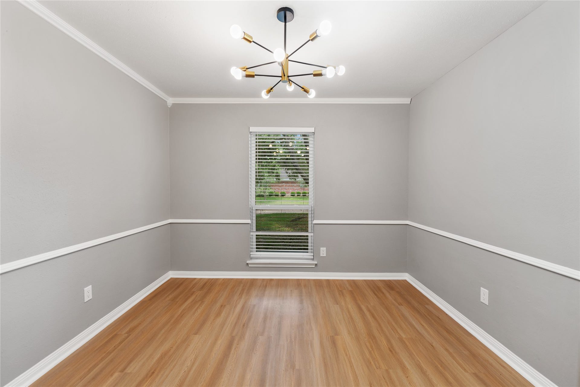 207 Burgundy Lane, League City, TX 77573 Spacious flex room with a modern light fixture and a well sized window overlooking the front yard. This versatile space can be used as formal dining or home office