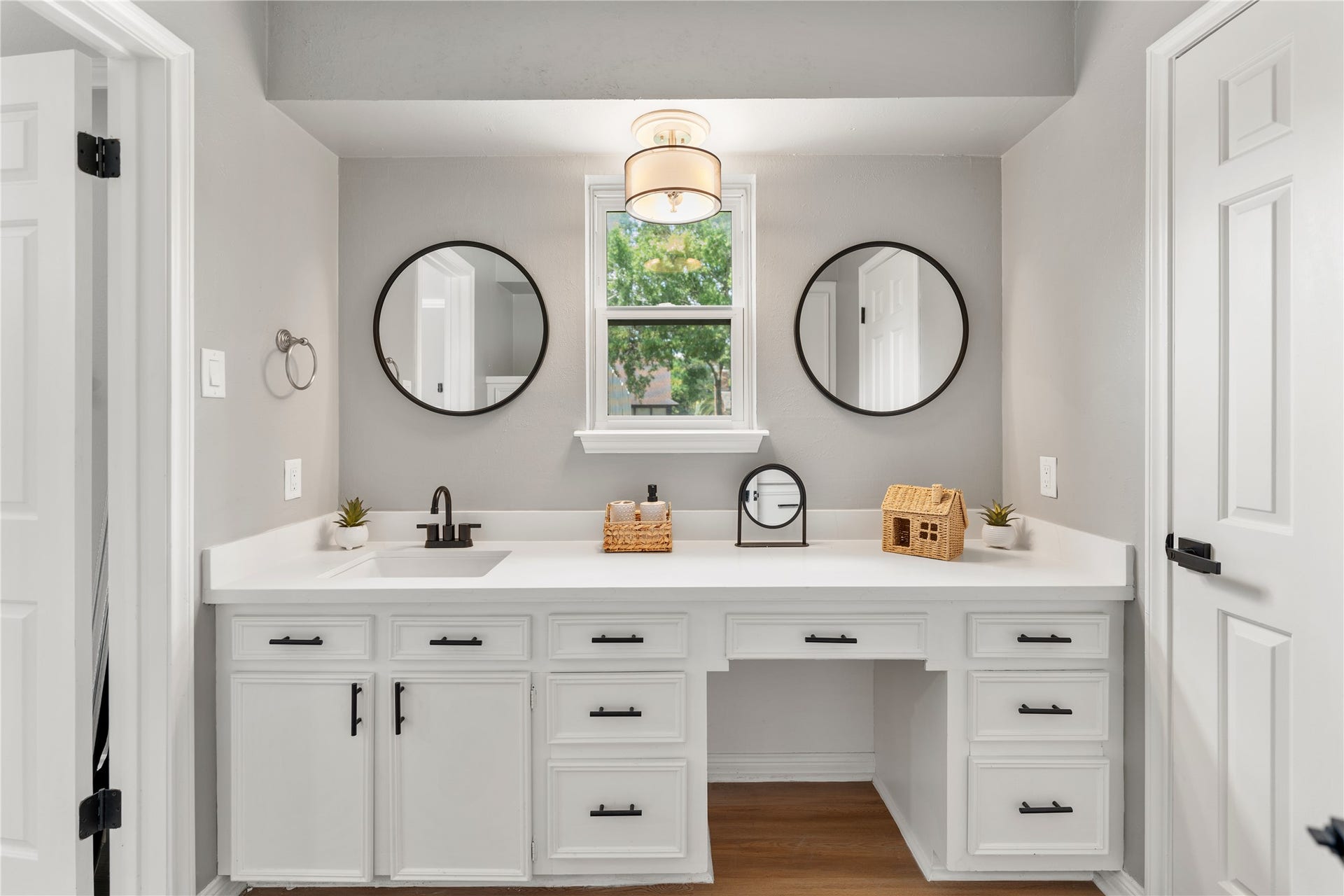 207 Burgundy Lane, League City, TX 77573 The bright, modern bathroom with quartz countertops, and sleek, contrasting fixtures, boasts ample storage space.