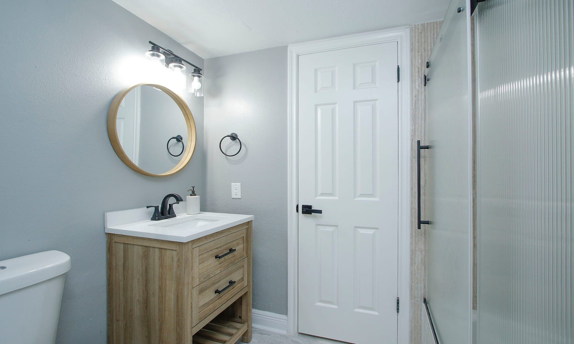 207 Burgundy Lane, League City, TX 77573 Alternate view of the bathroom, featuring a completely renovated shower / tub combo with frosted glass enclosure