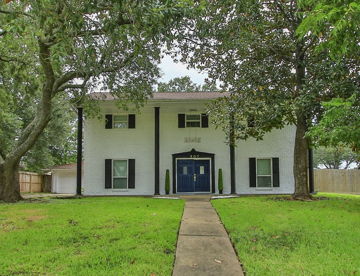 207 Burgundy Lane, League City, TX 77573 Majestic two-story home with a renovated facade, located in an oversized corner lot, framed by mature trees