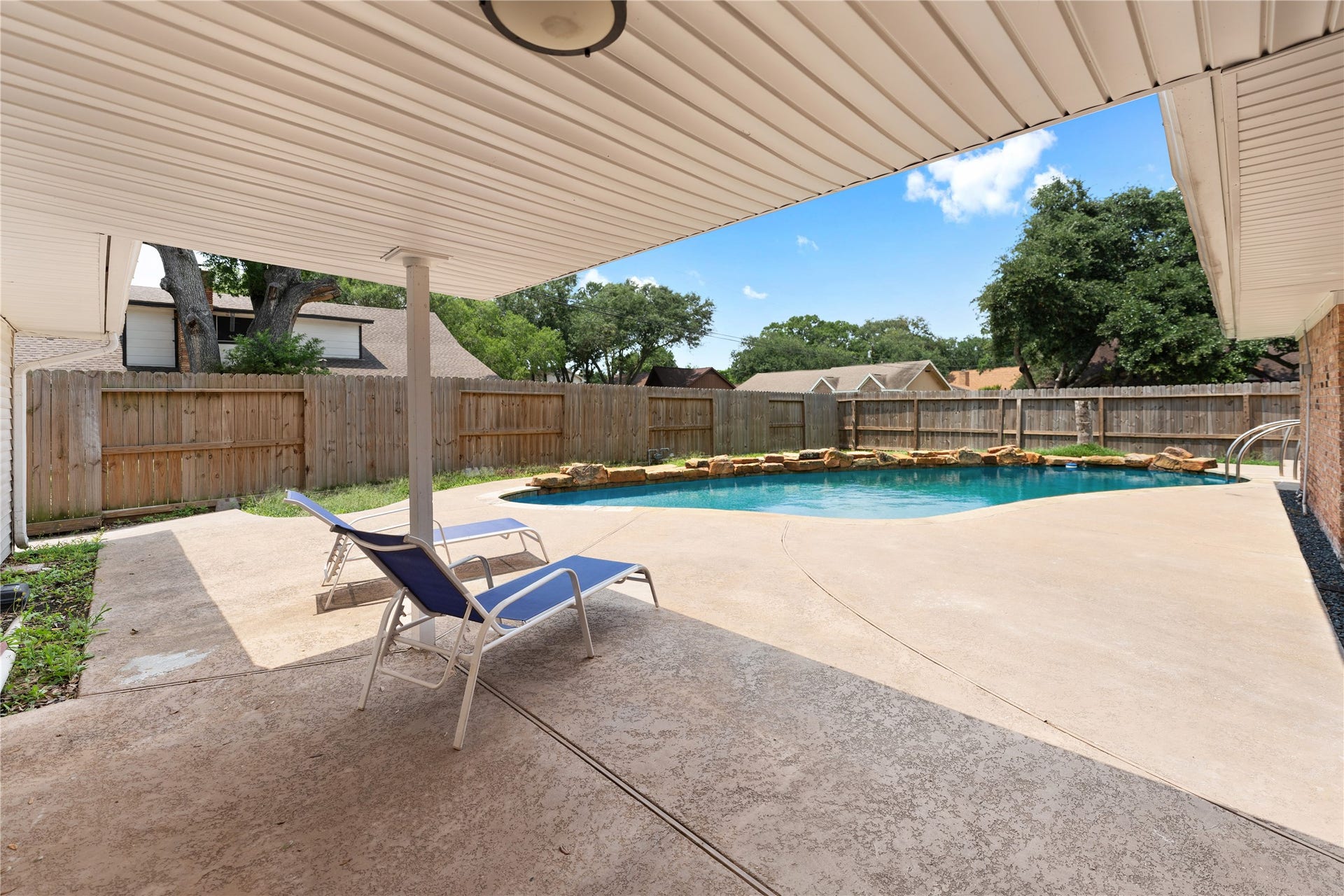 207 Burgundy Lane, League City, TX 77573 The backyard features an ample covered area surrounding the sparkling pool, ample enough to accommodate a table and lounging chairs