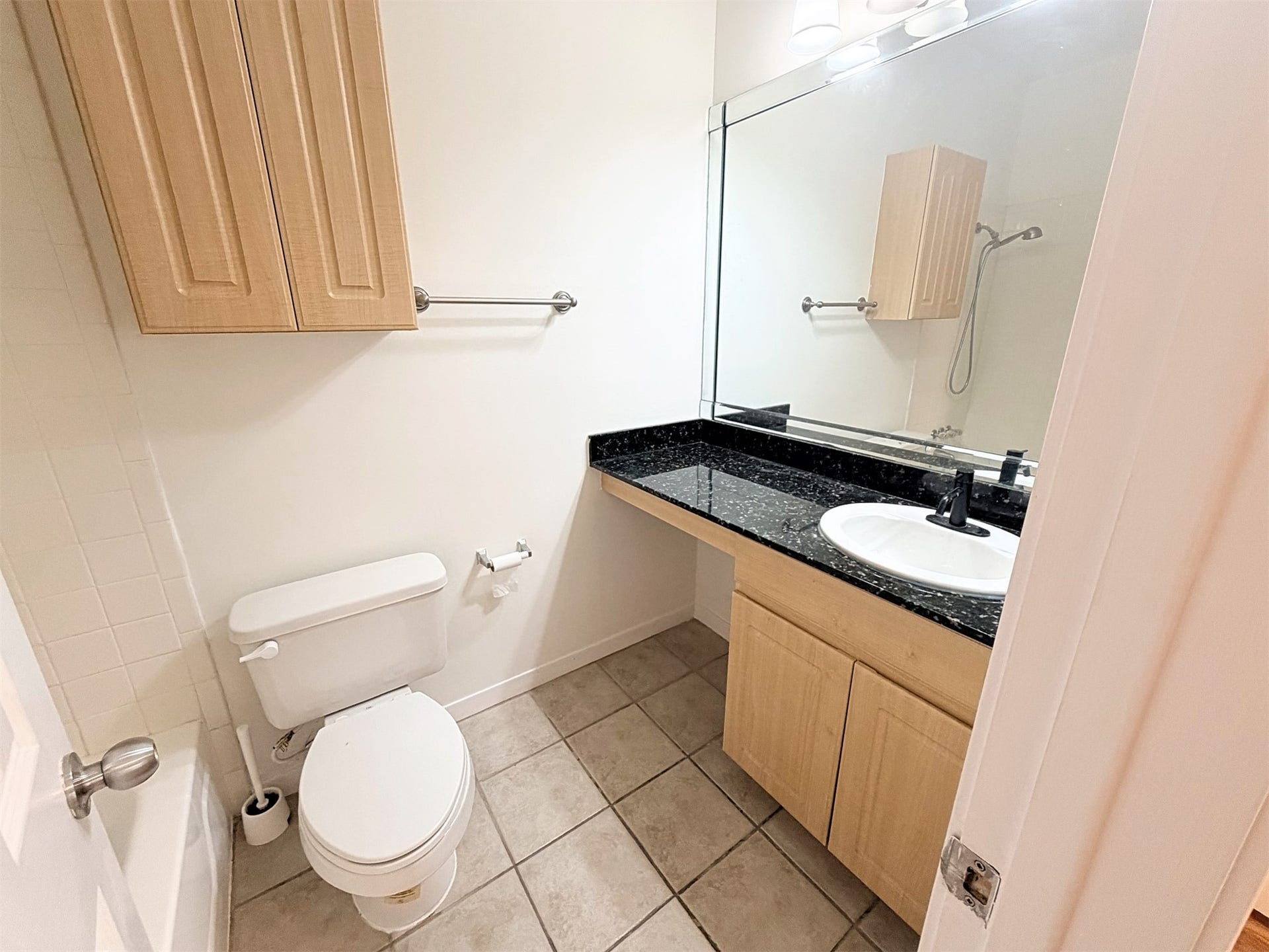 The ensuite bath features granite counters and tub shower.